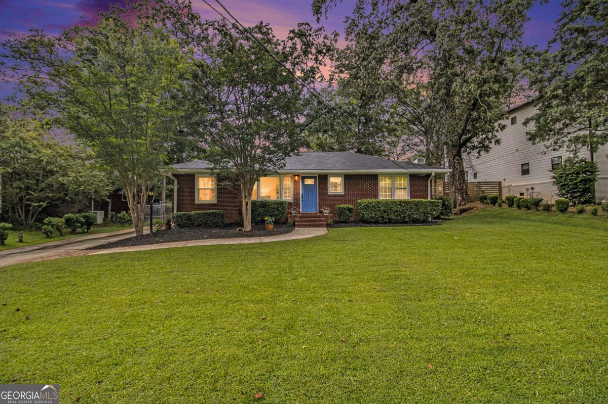 Welcome to Historic College Park! Nestled on one of the neighborhood's most desirable streets, this beautifully maintained brick ranch offers charm, convenience, and modern updates. Just a short stroll to Barrett Park and the renowned Woodward Academy Primary School, the location is hard to beat. This move-in ready home features a newer roof, updated HVAC systems, and freshly renovated bathrooms. The spacious primary suite includes a double vanity with granite countertops, generous storage, a walk-in closet, and a secondary closet. Original hardwood floors have been lovingly preserved throughout the main living areas and bedrooms, adding timeless character. The oversized two-car garage includes a built-in workshop area-perfect for extra storage, creative space, or weekend projects. Enjoy the community's rich history, local eateries, and scenic green spaces, all just minutes from vibrant Downtown College Park. Don't miss this exceptional opportunity!