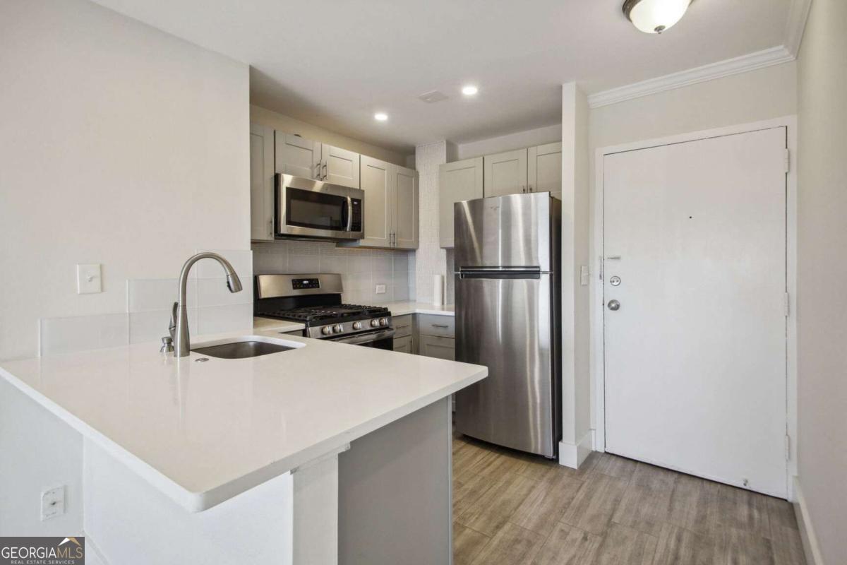 TOP FLOOR SKYLINE VIEWS Renovated 1 Bedroom 1 Bath in the Heart of Buckhead & Peachtree Battle Communities. Walk to Everything! Upgraded kitchen with white quartz countertop and all Stainless Steel appliances including high-end Gas Range. In-unit laundry. New everything including flooring and custom built-in shelving in the den and bedroom. Large step-in shower and more... Gated assigned parking in the garage. Where can you live in Buckhead at this price in a great location convenient to all major highways, Shepherd Center, Piedmont Hospital, Restaurants, Shopping, and the Beltline. Amenities include a swimming pool, grilling deck, large courtyard and gazebo, and fitness center. Solid Tenant on month to month. Please do not disturb tenant.