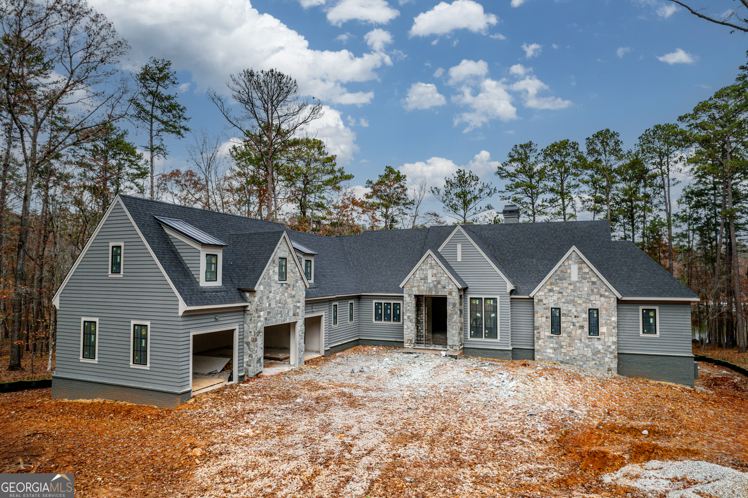 Welcome to this stunning new construction 6-bedroom, 6-bathroom estate with 2 additional half bathrooms, perfectly blending traditional and modern finishes throughout in the newest section of Reynolds Lake Oconee, Richland Pointe. Nestled on a private lakefront lot, this home offers a serene lifestyle with seclusion and a max dock for easy lake access.    Upon entering, you'll be greeted by beautifully crafted engineered hardwood floors that flow seamlessly through the open-concept living spaces. The gourmet kitchen is a chef's dream, outfitted with Sub-Zero and Wolf appliances, custom cabinetry, and ample workspace for hosting or family gatherings. A wine cellar provides the ideal setting for storing and showcasing your favorite vintages.    This home boasts two luxurious master suites, offering ample space and privacy for homeowners and guests alike, each offering a luxurious private retreat with spa-like bathrooms and walk-in closets.     The interiors are designed to impress with beamed vaulted ceilings that add character and elegance to the living spaces, while large windows fill the home with natural light.    The exterior is equally impressive with durable stone and Hardy Board siding, ensuring long-lasting beauty and low maintenance. The 3-car garage provides plenty of storage and convenience, and with plenty of room for entertaining, including spacious indoor and outdoor areas, this home is perfect for hosting friends and family year-round.    Whether you're hosting in the entertainment spaces or enjoying the tranquility of your private lakefront retreat, this home offers an unparalleled living experience. Call today to see this exquisite property that offers both luxury and comfort in one perfect package. Estimated date of completion April 2025.