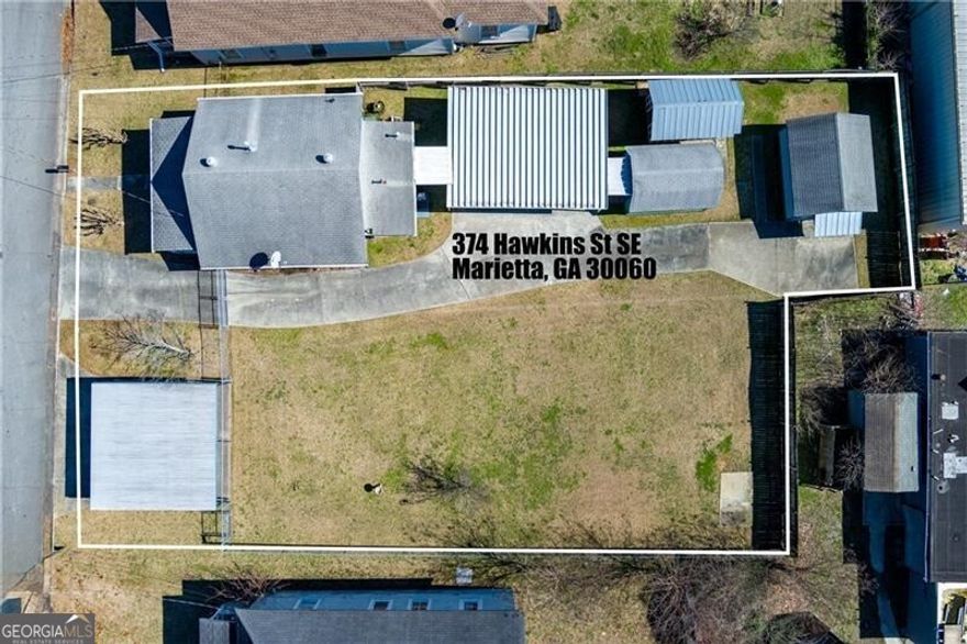 374 Hawkins Street is a 0.22 acre lot that currently holds a single family home, car shed, and 3 storage buildings. The Property is zoned LI (Light Industrial)  and surrounded by industrial buildings with 76 feet of street frontage on Hawkins Street in bustling Downtown Marietta. Utilize the current buildings for your business or utilize the land to build your personalized commercial space on the property. Adjoining lot, 365 Hawkins Street is also listed for sale.  This property is also listed for sale as a residential property- The property is zoned LI commercial but the current single family residence is grandfathered in by the City of Marietta as a residential property with restrictions on improvements. Great location for your next business!!!!
