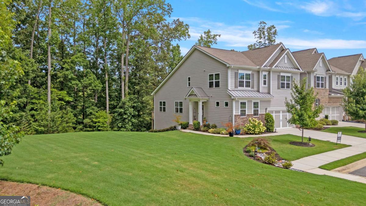 This stunning, one-of-a-kind townhome offers over 3,500 sqft and the ultimate blend of luxury, space, and convenience, featuring a FULL FINISHED BASEMENT, over $100,000 in premium upgrades, and sitting on one of the largest and most private lots in the community. Backing up to the protected Cheatham Creek, enjoy peaceful wooded views and a spacious side yard rarely found in townhome living. The AMENITY RICH neighborhood offers multiple pools (Olympic-style and resort-style), multiple tennis and pickleball courts, a fitness center, clubhouse, playground, community garden, and year-round neighborhood events. There's even an option to request your own garden plot, providing the chance to grow and maintain fresh produce close to home! Inside, a bright and airy foyer that flows effortlessly into the formal dining room and open-concept main living area. The kitchen is complete with a large pedestal island, breakfast bar, granite countertops, stainless steel appliances, tile backsplash, and pantry. The adjoining family room features a cozy fireplace and access to the upper deck for outdoor relaxation. MAIN LEVEL PRIMARY SUITE offers an elevated feel with tall ceilings, double vanity, and an oversized walk-in tile shower. Upstairs, a flexible loft landing connects two generously sized secondary bedrooms, and an additional full bath. Even a bonus room with an attached storage closet, ideal for a playroom or home office. The FINISHED BASEMENT is the true showpiece of this home, designed for entertaining in style. A sleek wet bar is the centerpiece, highlighted by a coffered ceiling, pendant lighting, stone backsplash, lighted glass display cabinets, and beverage coolers. Nearby, barn doors lead to a private bedroom, and an additional room offers versatility as a gym, media room, workspace, or potential fifth bedroom. The gorgeous full basement bathroom features a fully tiled walk-in shower, creating a luxurious guest experience. Step outside to a covered patio, perfect for hosting gatherings or relaxing in privacy as an extension of the basement and spacious yard. This home is also the only one in the community with its floor plan, making it a rare gem. Enjoy a professionally landscaped exterior, two-car garage, and incredible curb appeal. Lawn maintenance and trash pickup are included for low-maintenance living. Located near top-rated schools, shopping, dining, entertainment, healthcare, and major highways, this home truly offers more than just a place to live, it's a lifestyle. Don't miss your opportunity to own one of the most unique and upgraded homes in the neighborhood.
