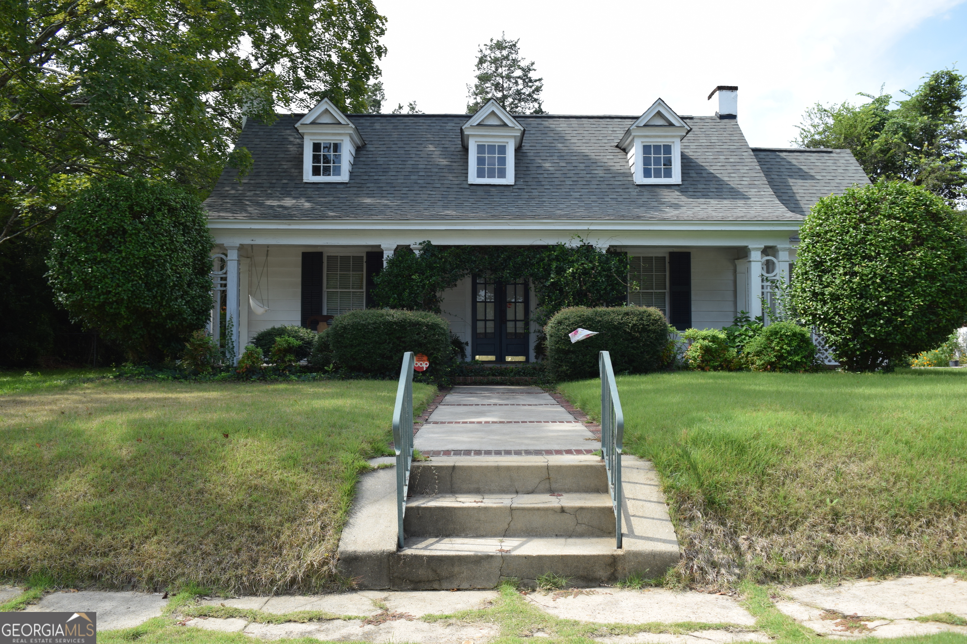Step into timeless elegance with this beautifully maintained 1925 cottage featuring 3 bedrooms, 2 bathrooms, and 1,616 sq ft of inviting living space. Nestled on a private 0.41-acre lot in the desirable Forsyth Circle area, this home blends historic charm with thoughtful modern upgrades. Inside, you'll find original hardwood floors and three decorative fireplaces that enhance the home's historic character and charm. The kitchen contains solid surface countertops and modern conveniences, while the formal dining room and spacious living areas make entertaining easy. The primary suite has been enhanced with a fully renovated bathroom, offering a cozy place to unwind. Additional upgrades include fresh interior paint throughout including trim and baseboards for a modern meets vintage vibes, plus a new roof installed in 2022 for peace of mind. Enjoy outdoor living on the side screened porch, or host gatherings on the terrace and patio. The front porch is framed by unique, thoughtfully designed landscaping, creating a warm and welcoming first impression that sets this home apart. Having a spacious entertaining space in the backyard, beautiful weather is sure to be enjoyed! The property also features full gutters, a fenced backyard, and an outbuilding/workshop for extra storage. Located just off Vineville Ave, this home offers quick access to dining, shopping, lively Downtown Macon, and only minutes from I-75. Don't miss your chance to own this one-of-a-kind Macon gem, a perfect balance of historic character, modern comfort, and undeniable curb appeal.