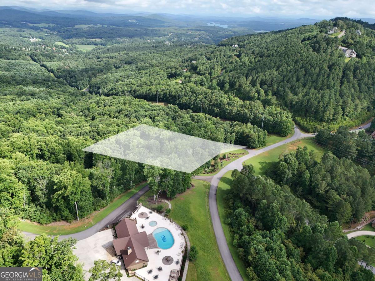 This beautiful private lot is located in the prestigious Thirteen Hundred on Lake Nottely gated community. This stunning 1.23 acre lot will offer breathtaking year-round long-range mountain views when you build your forever home and is truly a must see opportunity! Walking distance to the 5* Lodge/Clubhouse with stunning views, a luxurious saltwater pool, kiddie splash pool, fireplace, grilling and seating areas and full kitchen to enjoy the company of friends and family in a beautiful setting offering a blend of privacy, luxury and outdoor activities. Enjoy the marina including community boat docks with private boat ramp, swim platform, canoe/kayak launching area and outdoor grilling station. Enjoy the equestrian park with barn for your horse, riding area and walking trails. Ample camper and boat storage is available at a minimal cost for residents only. Paved roads, underground utilities, high-speed internet and public water available. Short-term rentals are allowed. Conveniently located close to Blairsville, Blue Ridge, Hiawassee and Murphy, NC for shopping, dining, golf, wineries and more. Come plan your dream home in the North Georgia Mountains!