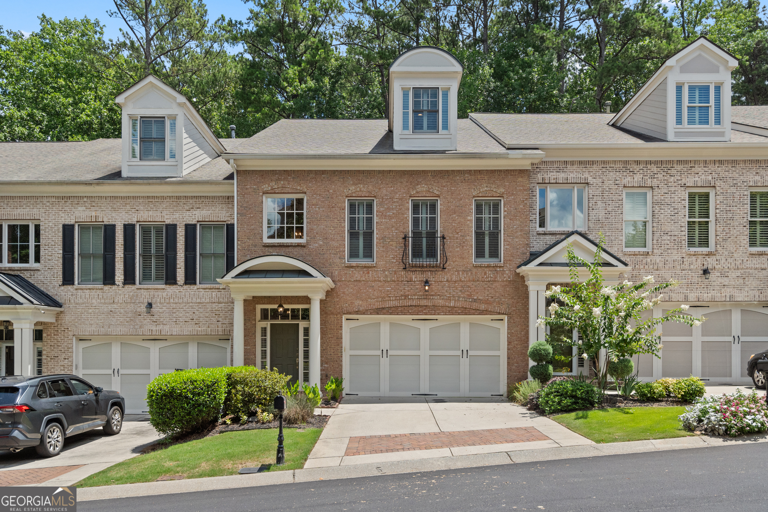 Stunning Brick Townhome with Elevator in Gated Myers Park - Prime Johns Creek Location! Welcome to this luxury 3 bed / 3.5 bath townhome nestled in the highly desirable gated community of Myers Park. Boasting elegant brick curb appeal and a thoughtfully designed open floorplan, this home is filled with high-end upgrades and modern conveniences-including a private elevator. Step inside to soaring 10-foot coffered ceilings, plantation shutters, rich custom trim work, and built-in cabinetry that add timeless sophistication. The main level features a cozy library or sitting area, an expansive family room, formal dining area, and a chef's kitchen with an oversized island, walk-in pantry, extra cabinetry, and a wine cooler-perfect for entertaining. The second floor offers a versatile loft area ideal as a secondary family room, media space, or home office. Retreat to the spacious primary suite with a private sitting area and luxurious en-suite bath. An additional bedroom and full bath complete this level. The third floor is perfect for a private teen or in-law suite, offering a huge bonus room, bedroom, and full bath. Enjoy the fenced-in brick patio-a serene and private outdoor space. Ideally located near the back of the neighborhood, this home is just steps from a dog-walking trail and within walking distance to top-ranked schools. Low-maintenance living with low HOA fees that cover landscaping, termite, trash, pool, fitness center, and clubhouse amenities. Don't miss this rare opportunity for elegance, space, and convenience in one of Johns Creek's most sought-after communities!