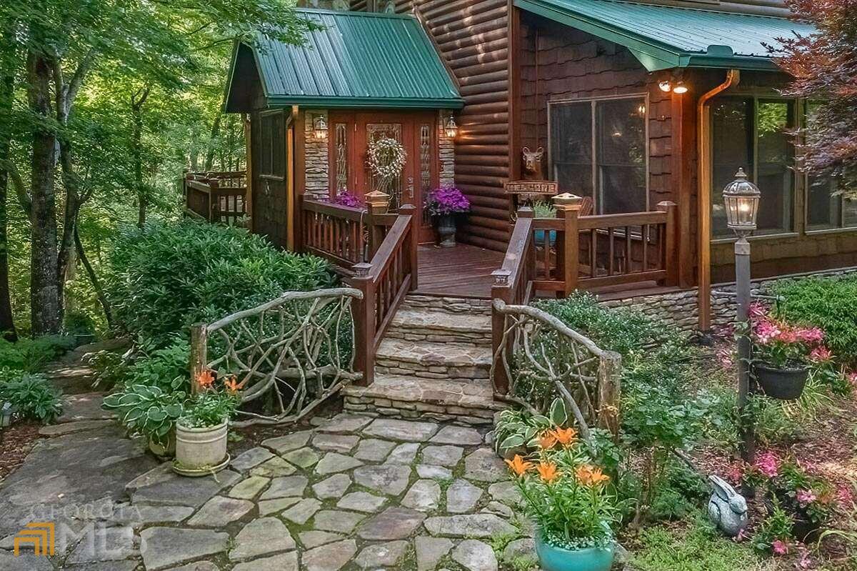 Are you looking for serenity in the mountains? You may have just found the perfect spot!! The home of this Master Gardener offers an unrivaled combination of privacy & Convenience with all paved roads, including a large level paved driveway & additional parking area. Located less than 5 minutes from Downtown Blue Ridge. The beautifully landscaped grounds are second to none. A stone path is your guide thru the garden of Japanese Maples, Dogwoods & native hardwoods. Extensive rock work & raised garden beds add to the enjoyment of the garden. The cabin was remolded in 2013 & now offers an updated expanded kitchen with granite countertops, SS appliances & large center island with a walnut top. Updated bathroom & full laundry on the main level. Additional amenities: stone fireplace with wood burning insert, mountain laurel accents, plantation shutters, large back porch & potting shed on the lower patio. May the spirit of Minnehaha find you peace and serenity.