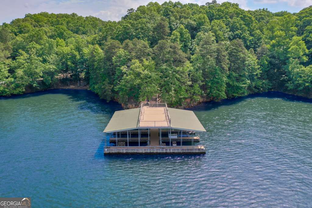 Bring your choice of builder and start your dream lake retreat in one of the well established lake neighborhoods. 2 Acre Deep-Water Lot In A Very Private Luxury gated Community with the luxury properties On Lake Lanier. 345 FT Of Corp/Waterfront Footage, All City Utilities are available. Covered Six Slip Community Dock With Party Deck On Top.There is an easy walking path to the dock.1 Dock Slip Included In Sale. Total of 3 Lots Available, From 2-6 +/- Acre Each, 1 Dock Slip Included With Each Lot. Quick and easy interstate access and located only 5 minutes from the shops and restaurants in downtown Gainesville.