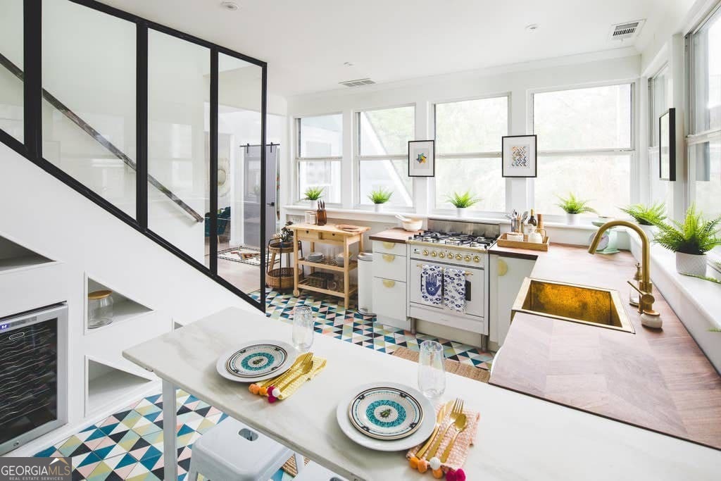 Step into this stylishly updated 2-bedroom, 1.5-bathroom home that blends comfort, character, and convenience across two spacious levels. From the moment you walk in, you'll notice the vibrant, eclectic living room designed for both relaxation and entertaining. The kitchen comes fully equipped with modern updates and even includes a wine cooler, making it perfect for hosting friends or winding down at the end of the day. Upstairs, the full bathroom feels like a spa with its dual vanity, skylights, and eye-catching tiled feature walls in bold, vibrant colors. Both bedrooms offer sizable closets and come thoughtfully furnished with cozy mattresses, 100% cotton linens, fluffy down pillows, and proper fitted sheets to give you that hotel-quality rest every night. The home also includes a screened-in covered porch and an attached outdoor patio, giving you plenty of options to enjoy Atlanta's weather in comfort. In-unit laundry, fast WiFi, and a smart TV make everyday living easy, while Ring doorbell cameras and custom-coded keyless entry provide added peace of mind for your security. This FULLY FURNISHED rental is available with FLEXIBLE LEASING options. The listed price reflects a 12-month lease, but shorter terms are available-just contact the agent for details. All utilities can be included upon request, and short-term stays are welcome (please note that rates and utility charges may differ). If you are displaced due to a hurricane or local event, please flag this with us-we are here to help. Conveniently located in the heart of Atlanta, 449 Greenwood Ave Unit 3 offers a unique balance of style, comfort, and flexibility, making it much more than just a rental-it's a place you'll be glad to call home.
