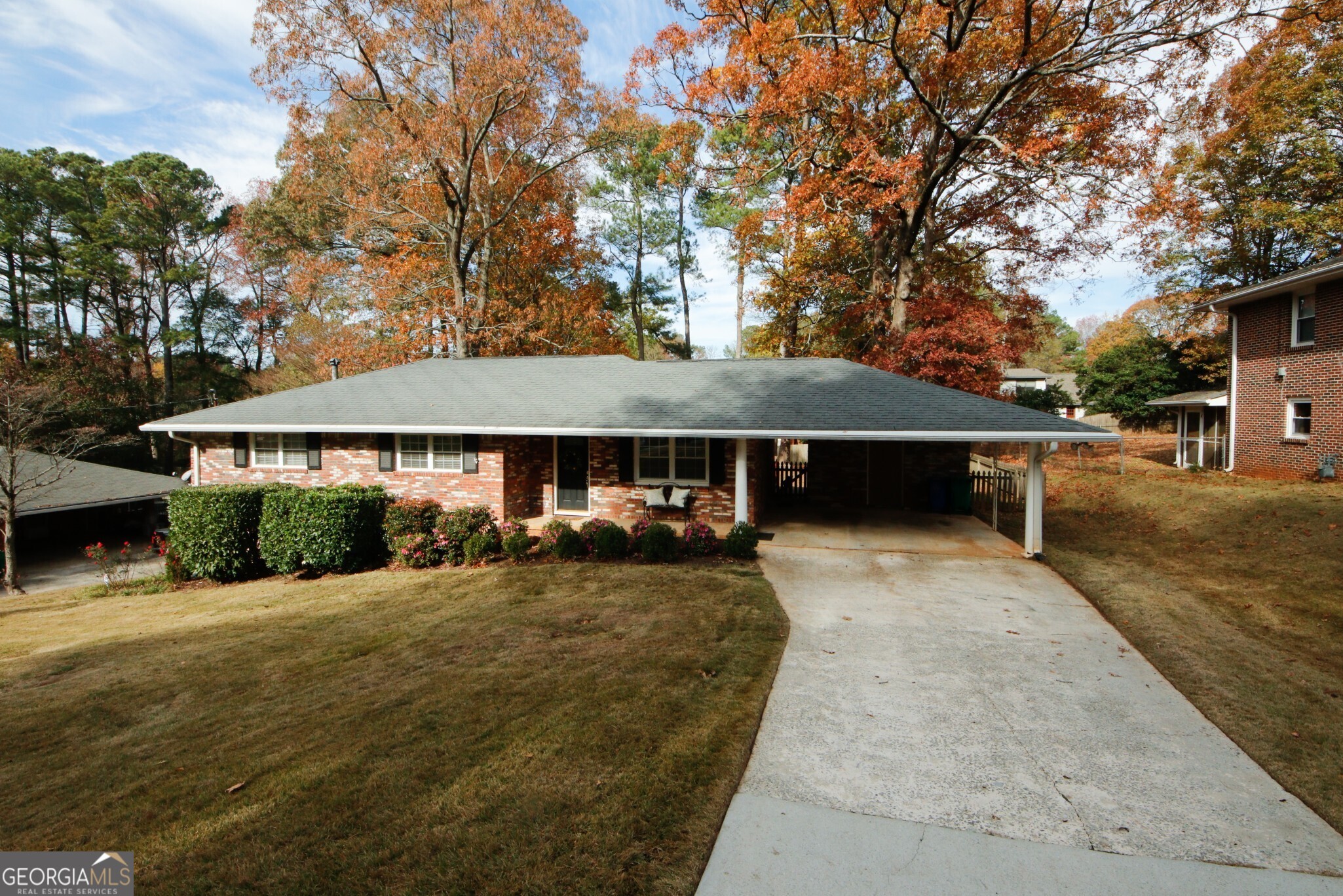 This delightful all-brick ranch home offers four bedrooms and two bathrooms. The main level features beautiful hardwood floors throughout with tile in the kitchen and dining area.  The updated kitchen includes sleek granite countertops and stainless steel appliances. The open kitchen flows into a spacious family-style dining room, which offers easy access to a large deck perfect for outdoor entertaining overlooking a generous, fully fenced backyard.  Each of the three (3) main floor bedrooms are equipped with ample closet space, and the main-level bathroom boasts luxurious marble tiles, a bidet, and a vaulted ceiling. Updates to the home include energy-efficient dual-pane windows.  The basement includes a private bedroom with exterior access, as well as a full bathroom with a shower/tub combination. The unfinished basement is currently used as a workshop, with the laundry area conveniently located here as well. The property also features a two-car carport with an additional large exterior storage room for all your tools and equipment.  Conveniently located within walking distance of shopping, schools, and public transit, this home is situated in the vibrant and growing community of Tucker an ideal place to call home.
