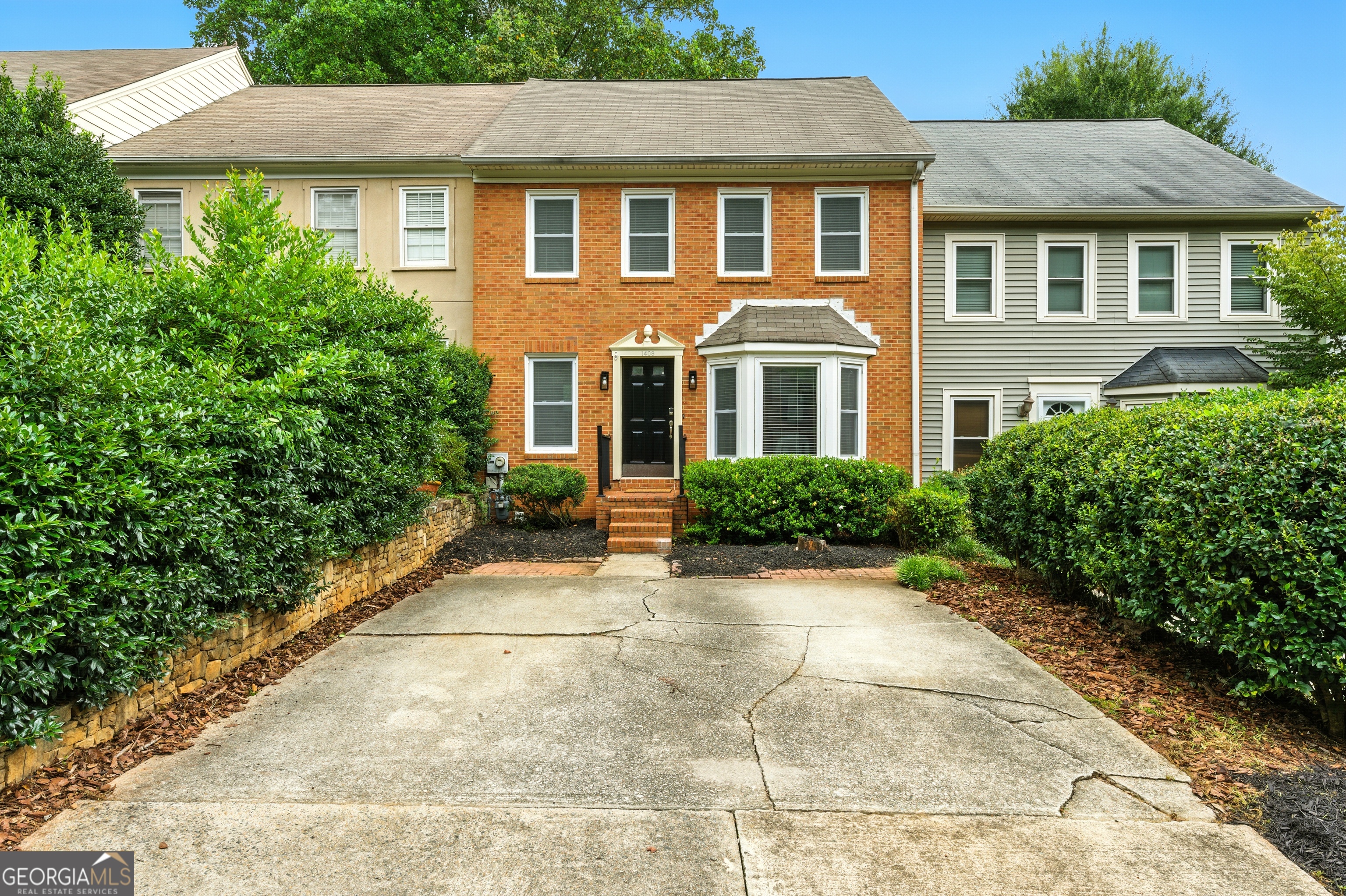 Welcome to this stunning townhome in the highly sought-after Salem Ridge community! This spacious, three-level brick-front residence offers one of the best price-per-square-foot values in the area-an opportunity you won't want to miss. PRIME LOCATION: Perfectly situated for convenience, you can stroll to nearby shops and restaurants, while The Battery and Truist Park are just two miles away. Quick access to both I-75 and I-285 makes commuting a breeze. Outdoor enthusiasts will love being just a quarter mile from the Bob Callan Trail extension, which links seamlessly to the entire Cumberland multi-use trail system. INTERIOR FEATURES: Inside, you'll find a beautifully updated home with a fully renovated kitchen, remodeled bathrooms, two brick fireplaces, and upgraded windows throughout. The kitchen shines with modern cabinetry, granite countertops, stainless steel appliances, and a charming bay window overlooking the tree-lined street. It opens into the bright, open-concept living and dining room centered around a cozy fireplace. BEDROOM SUITES: Upstairs, the primary suite serves as a true retreat with its own fireplace, dual vanities, a tiled shower, and two walk-in closets for exceptional storage. The secondary bedroom also has an en-suite bath and a large walk-in closet, making it ideal for guests, roommates, or loved ones. VERSATILE TERRACE LEVEL BASEMENT: The finished lower level adds incredible flexibility with a full bath and private deck. Use it as a third bedroom, home office, gym, media room, or in-law suite. Generous closet space and an additional bonus room and unfinished storage area add to the functionality of this level. OUTDOOR LIVING: Enjoy morning coffee or evening relaxation on two private decks overlooking mature trees and a grassy backyard ready to fence. The quiet, tree-lined setting enhances the home's charm and privacy. INVESTMENT POTENTIAL: With low HOA dues of just $12 per month and no rental restrictions, this property is not only a wonderful primary residence but also a smart investment. Don't miss your chance to own this move-in ready Salem Ridge townhome. One or more photos have been virtually staged.