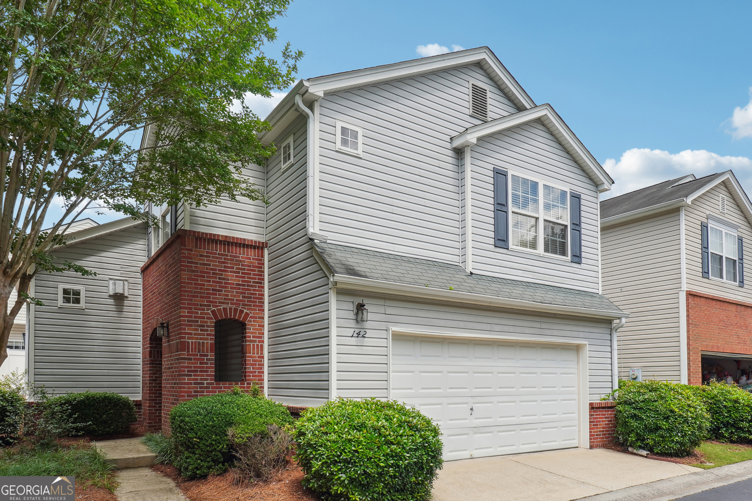 Welcome to this charming two-story home located in the highly sought-after River Park Subdivision. This residence offers 2 bedrooms plus a versatile loft that can easily be converted into a third bedroom. The master bedroom is a tranquil retreat featuring a separate shower, oversized vanity and luxurious soaking tub. The heart of the home is the stunning freshly painted two-story great room, complete with a cozy fireplace and abundant natural light which flows into dining area. The kitchen is a chef's dream, boasting white cabinets, granite countertops, stainless appliances, a breakfast bar and modern appliances. Situated on a fenced lot at the end of the street, this home offers a private backyard with a patio - perfect for outdoor entertaining. It also includes a two-car garage. The neutral paint palette and newer water heater add to the move-in readiness of this home. Additionally, the HOA maintains the front yard, ensuring a well-kept exterior with minimal effort. Residents of River Park Subdivision enjoy access to fantastic amenities including a clubhouse, pool, tennis courts and playground. All of this is just minutes away from downtown Woodstock, offering convenience and a vibrant lifestyle.
