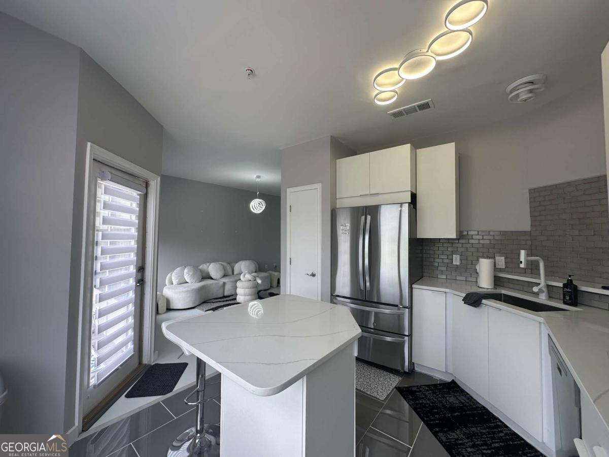 Bright, modern condo just steps from The Beltline, Lee + White, and major interstates-plus right next to the upcoming West End Mall development. Features quartz countertops, Bosch dishwasher, double French door fridge, Jacuzzi tub, electric fireplace, and private balcony. Recent updates include new lighting, fixtures, and plumbing. Move-in ready in one of Atlanta's fastest-growing areas