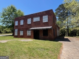 Social Circle - Fixer Upper , currently zoned Residential, Investors Dream with Lots of possibilities, sewer available per city, Nice Corner Lot, own a piece of history, Great to restore as Building with Loft, Property Sold as is. - Possible Special Use -