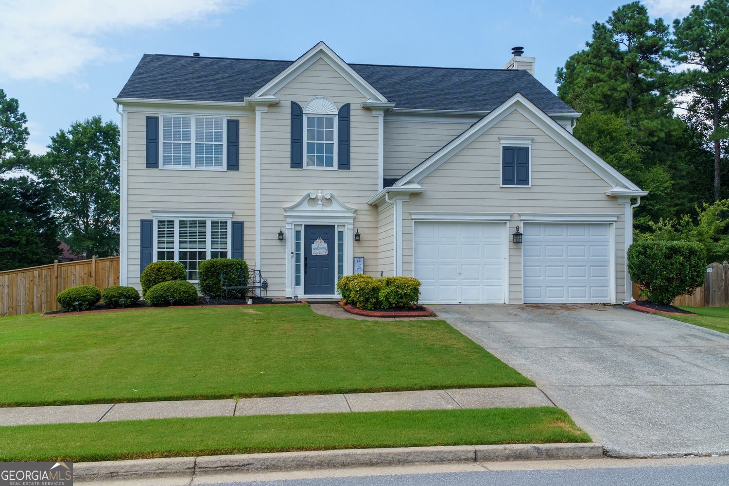Charming Home on a Spacious Corner Lot in Desirable Brookshire! Close to Downtown Woodstock and The Outlet Shoppes of Atlanta. Welcome to this beautifully updated two-story traditional nestled on a large, fenced-in corner lot in the sought-after Brookshire community. Step inside to brand new luxury vinyl plank flooring throughout the main living areas and enjoy the open-concept living/dining room-perfect for entertaining. The kitchen is open and bright with sleek stainless steel appliances, a cozy breakfast area, and views into the spacious family room featuring a warm fireplace. A convenient powder room and a two-car garage complete the main level. Large fenced in backyard with oversized patio and firepit, great for cookouts and the perfect spot for playground/trampoline and all the outdoor fun. Upstairs, you'll find a generous primary suite with an oversized en-suite bath that includes a walk-in shower, garden tub, and a large walk-in closet. Three additional bedrooms share a beautifully updated hall bathroom with a double vanity and modern stand-up shower. The laundry room is also conveniently located upstairs. Freshly painted throughout with all-new lighting, this home is move-in ready! Enjoy resort-style amenities including two sparkling pools, tennis courts, a playground, and more. Don't miss this opportunity to own a stunning home in one of the area's most popular neighborhoods! Great location close to the outlet mall and downtown Woodstock and Canton.
