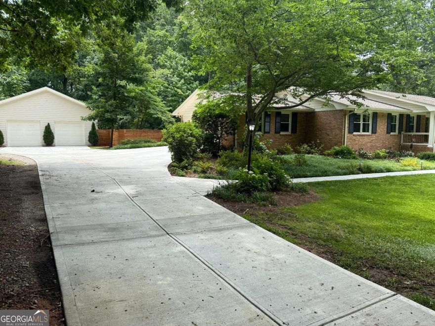 Beautifully Updated All-Brick Ranch in Smoke Rise - Over 1 Acre with Saltwater Pool & Huge Detached Garage!        Welcome to this spacious 4BR/2.5BA all-brick ranch on a level 1+ acre lot in the highly desirable Smoke Rise community of Tucker. This well-maintained home offers a blend of timeless charm and modern updates, including real hardwood floors throughout, an updated kitchen with granite countertops & stainless steel appliances, 5 burner gas cook top and a renovated primary bath with double vanities and a large walk-in tiled shower. Enjoy outdoor living with a rocking chair front porch, screened back porch, deck, and a saltwater pool (3-year-old pump) surrounded by professional landscaping/lighting/irrigation and a custom privacy fence. A 2 car attached garage and a new 30x30 detached 2 car garage/ workshop with 12-ft ceilings, 60-amp service, and a 30-amp outlet offers space for car enthusiasts, hobbyist, tools and equipment. The basement features a bar area, walkout access to the backyard, and a large unfinished workshop space. Additional features include: New driveway/sidewalk, New architectural  roof, gutters, & windows, water heaters (instant hot water) & HVAC recently replaced, New Insulation, Two additional sheds/workshops, RV parking area and so much more !        More than just a neighborhood, Smoke Rise is a lifestyle. Known for it's rolling hills, mature trees, large private lots and custom homes. Located just minutes from Smoke Rise Country Club, which offers golf, tennis, dining, and social events, and within the charming City of Tucker, known for its vibrant Main Street, community events, and excellent schools. Easy access to major highways and outdoor recreation at nearby city parks and the famous Stone Mountain Park.       This is a rare opportunity to enjoy space, privacy, and convenience in one of Tucker's premier neighborhoods! Don't delay! Schedule a private showing today!