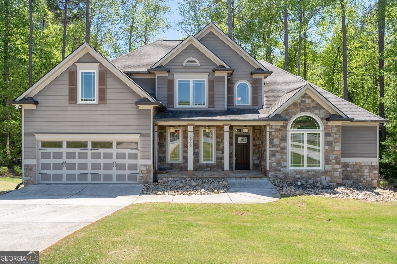 Rare find! This beautiful 5-bedroom, 3-bathroom home sits on a private cul-de-sac in sought-after Heritage Green. With both the primary suite and a guest suite on the main level, this layout is perfect for convenience and flexibility. The open-concept design includes a bright kitchen, a cozy family room with a fireplace, and a private backyard with a deck. Upstairs, three additional bedrooms and a full bath provide plenty of space. Plus, the 812 sq. ft. unfinished basement offers great storage or expansion potential. Just minutes from downtown Marietta's shops, dining, and entertainment, this home is a must-see!