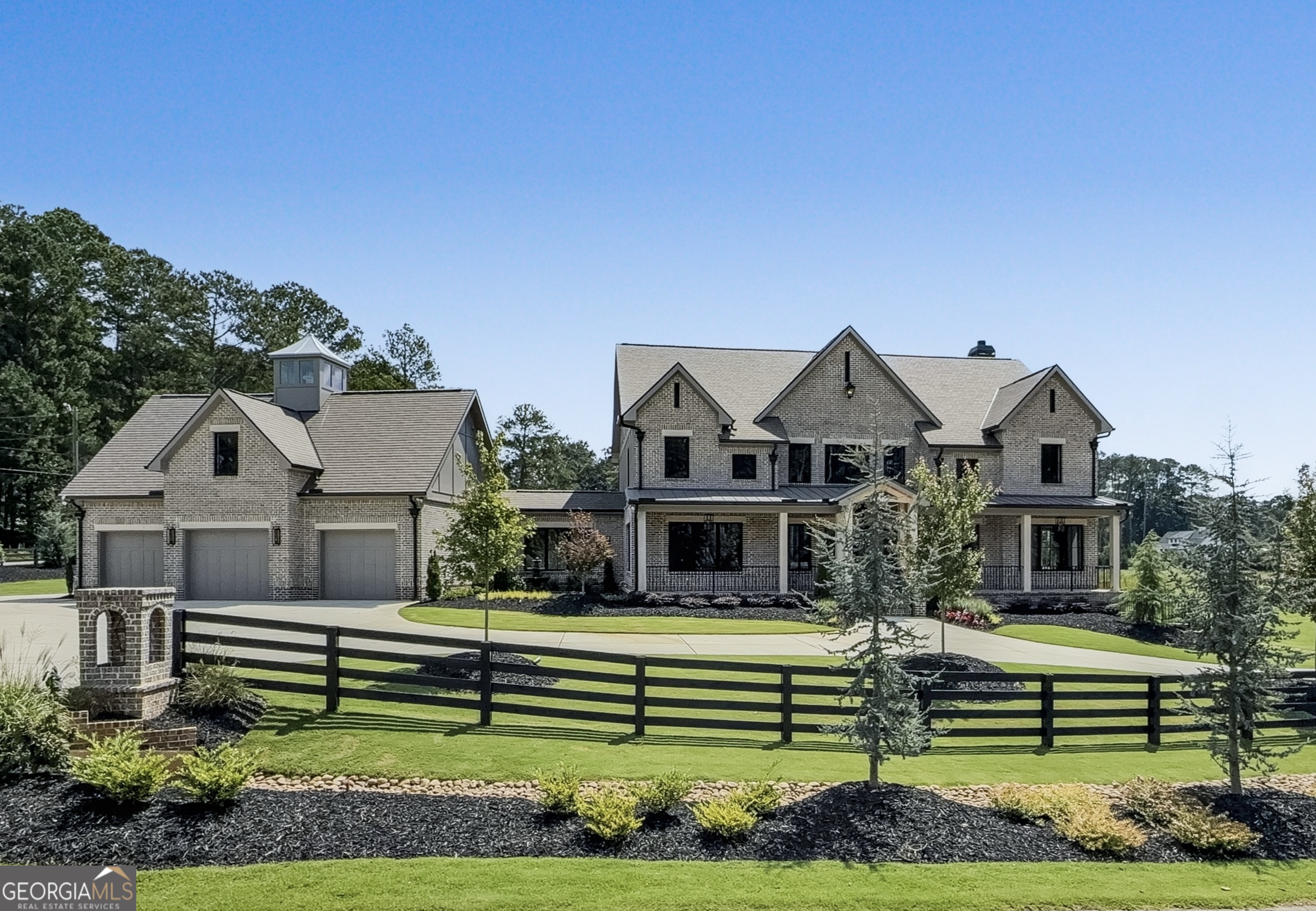 Welcome to an extraordinary expression of craftsmanship and modern luxury. As you arrive via one of two stately driveways, you're greeted by grand columns crowned with glowing gas lanterns, an elegant prelude to the refined living experience that lies beyond. Expertly crafted with uncompromising attention to detail, this brand-new construction home blends timeless architectural beauty with cutting-edge technology and enduring materials. Every inch of this stunning Craftsman-style residence has been thoughtfully designed to elevate everyday living into an experience of elegance and ease. Set in the heart of Alpharetta's prestigious Cherokee County, this home is a rare find, combining the charm of suburban serenity with the convenience of nearby top-rated schools (Avery, Creekland, Creekview, and The Haven Academy), premier shopping, fine dining, and expansive parks. Striking brick construction lends warmth and stature to the exterior. Inside, rich stain-in-place hardwoods span the home, paired with handcrafted custom cabinetry and high performance concrete countertops with built-in sinks. The chef's kitchen and outdoor culinary space feature elite Wolf and Sub-Zero appliances perfect for entertaining or quiet evenings at home. An expansive 1,000-square foot covered patio with herringbone brickwork, built-in heaters, and gracious open air living invites you to relax and unwind year-round. The primary suite offers a spa-like escape with heated tile flooring and a professionally designed, boutique style master closet. This smart home is prewired for EV charging and offers full mobile control of HVAC, lighting, surround sound, and Lutron window shades bringing convenience to your fingertips. The F-Wave premium synthetic roof, with a lifetime warranty, offers protection against 130+ mph winds, Class 4 hail, and Class A fire. Jeldwen Casement windows come with a 10 year frame and 20 year glass warranty. Nearly 10,000 square feet under roof, including garage and covered porches. Backyard approved for a future in-ground pool. Located within a private enclave of just 7 expertly curated new homes (lots not sold individually). Showings are available with Proof of Funds or a Pre-Qualification Letter. Listing agent will accompany all showings to provide personalized insights into this impeccable home. Schedule your showing today and ask me about our creative financing options!