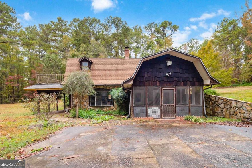 Nestled at the end of a quiet gravel road, 170 Pebble Path in Douglasville offers a rare opportunity to own a truly unique property on a sprawling 2.67-acre private oasis. This charming 3-bedroom, 2.5-bath home spans nearly 3,000 square feet and is brimming with character and potential. The heart of the home features a gorgeous custom-built stone fireplace, a testament to the handcrafted stonework that adds warmth and rustic elegance throughout the living space. Multiple outdoor living areas-including a screened front porch, a covered patio off the living room, and a private deck off the upstairs primary suite-invite you to relax and soak in the serenity of the surrounding woods. This secluded retreat offers endless possibilities. With no through traffic and nature as your neighbor, this is the peaceful escape you've been waiting for. 166 Pebble Path as well!