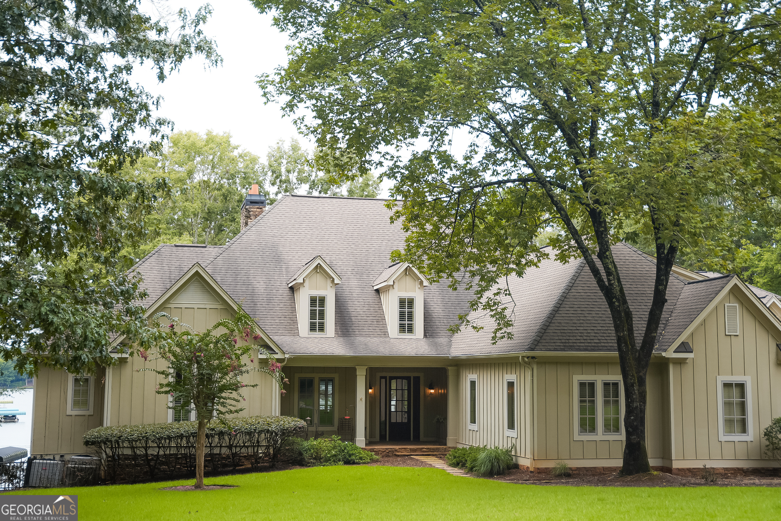 Lakefront Luxury Estate on Lake Oconee Near Ritz-Carlton & Reynolds Golf Exceptional 5-bedroom, 5.5-bath, 9,495 sq. ft. custom-built estate on 1.07 acres of prime lakefront property on Lake Oconee, just across from the Ritz-Carlton and Reynolds Plantation championship golf courses. Enjoy an open floor plan, soaring beamed ceilings, hardwood floors, and French doors to covered decks with panoramic water views. The gourmet chef's kitchen features granite counters, custom cabinetry, a large island, and professional-grade appliances. The main-level master suite boasts a coffered ceiling, private lakeview deck, spa bath with soaking tub, walk-in shower, dual vanities, and custom closets. The lower-level entertainment complex includes a stone fireplace, wet bar, wine storage, home gym, and recreation areas. Multiple bonus rooms, offices, and climate-controlled storage offer versatile living options. Outdoor spaces include screened porches, covered terraces, and beautifully landscaped grounds perfect for year-round waterfront living. Move-in ready with premium finishes throughout.