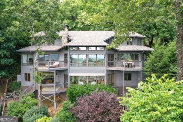 This is the GA mountain retreat you have been looking for! It is a spectacular custom Home nestled in the mountains of Big Canoe. Enjoy short and long views as far as the Atlanta Skyline. Artist/Architect designed, this home with its open floor plan, seamlessly integrates nature into every corner. Antique pegged wide-pine floors, exposed beams, and abundant windows create a bright and inviting atmosphere. Step outside to admire the beautiful gardens and pet-friendly yard, complete with several private patio areas perfect for outdoor entertaining. Remote control awnings over the living room windows ensure optimal outdoor exposure. Too many special features to mention. You must see it to appreciate the craftmanship. Welcome to your new mountain retreat with a private view from 'every' angle. Welcome to North Georgia and the southern point of the Appalachian Trail.