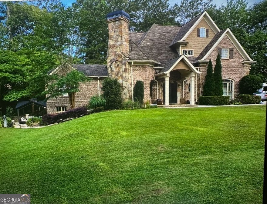 European Old World charm with modern updates in the heart of sought after East Cobb Walton High School location! This unique & versatile property can be enjoyed as a 3 bedroom, 2.5 bath single family residence with roommate/in law suite OR since there are separate entrances as a duplex/investment Airbnb income producing property. If you are looking for multigenerational living or you want to host a short term rental while maintaining your own space, the possibilities are endless! The thoughtful design features a main level with 3" thick field stone, exposed brick walls, and real hardwood floors throughout, an open concept family room and gourmet kitchen with quartz countertops, huge breakfast bar, walk-in pantry, high-end stainless steel appliances (36" Thermador gas stove), and upscale Wellborn kitchen cabinetry. Main level also offers a half bath off of kitchen and access to the attached 3 car garage with large storage room. Back inside, main level offers a luxurious primary suite with en-suite bathroom including double marble vanities, separate dressing vanity, large walk-in shower, walk-in closet, and laundry room. The upper level offers option for a 2nd separate residence with 2 more bedrooms, full bath, 2nd full kitchen, large walk-in pantry, second laundry room, and family room...OR...Design allows for quick conversion of 2nd kitchen to 4th bedroom. The lower/terrace level boasts a large 3rd living room/media room/bedroom with built-in office nook, storage space & safe room that leads outside to a covered lanai overlooking the meticulously maintained .9 acre, lush & level lot. The rest of the outdoor experience is complete with a brick and stone turret lanai with built-in fireplace for year round enjoyment & entertaining. Located close to the areas most highly rated schools, shopping, dining and entertainment, this unique property will not last...Call to schedule your tour today!!