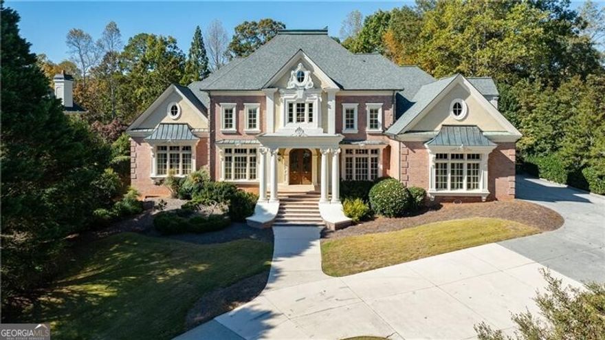 Exquisite European-Inspired Estate in Country Club of the South is set along a fairway of the prestigious Country Club of the South golf course. This elegant all-brick European-style residence combines timeless architectural detail with modern sophistication and offers unparalleled craftsmanship throughout. A stately front portico with a coffered ceiling and double entry doors opens to a soaring 20-foot foyer entry, setting the stage for the home's grand yet inviting ambiance. The open and airy floor plan flows effortlessly from the curved floating staircase to the two-story great room, framed by floor-to-ceiling windows and features one of five exquisite stone fireplaces. Flanking the foyer are the banquet sized formal dining room and an elegant study featuring rich built-ins, coffered ceilings, and a fireplace. The chef's kitchen is a culinary masterpiece, featuring top-tier appliances, a large center island with bar seating, walk-in pantry with built-in ladder, and a butler's pantries. The adjoining breakfast room and keeping room-complete with fireplace and terrace access-create a perfect setting for everyday living and entertaining with sweeping views of the golf course. The primary suite on the main level is a private retreat with a fireside sitting area, two custom walk-in closets, and a luxurious marble bath with dual vanities, make-up desk, jetted soaking tub, and multi-head shower. Upstairs, you'll find two en-suite bedrooms, each with private baths and large closets and two bedrooms with an adjoining bath, each with large closets. An expansive finished attic (over 1,000 sq. ft. not included in the total square footage) with permanent stair access finishes off the 3rd level. This space offers conditioned air and is ready to customize.  The terrace level is designed for entertaining on a grand scale, featuring a full secondary kitchen,, fireside family room, game and fitness areas, home theater, office, hobby and tool rooms, and a stunning English pub bar adjoining a temperature-controlled wine cellar and tasting room. There is also a guest en-suite with an adjoining bath and large closet space.  Outdoor living is equally impressive with a fenced, level backyard and upper and lower stone terraces overlooking the manicured golf course-ideal for relaxation or entertaining. The property also offers ample space for a custom pool addition. Located just steps from the community clubhouse, pool, and tennis facilities, this residence provides easy access to all the world-class amenities that define Country Club of the South-including 24/7 gated security, tennis and pickleball courts, Olympic-sized pool with waterpark, playground, tot lot, basketball courts, community park, and year-round social events. Optional Country Club membership is available which includes a Jack Nicklaus Signature Golf Course. Experience refined living and timeless elegance in one of Atlanta's most prestigious gated golf communities.