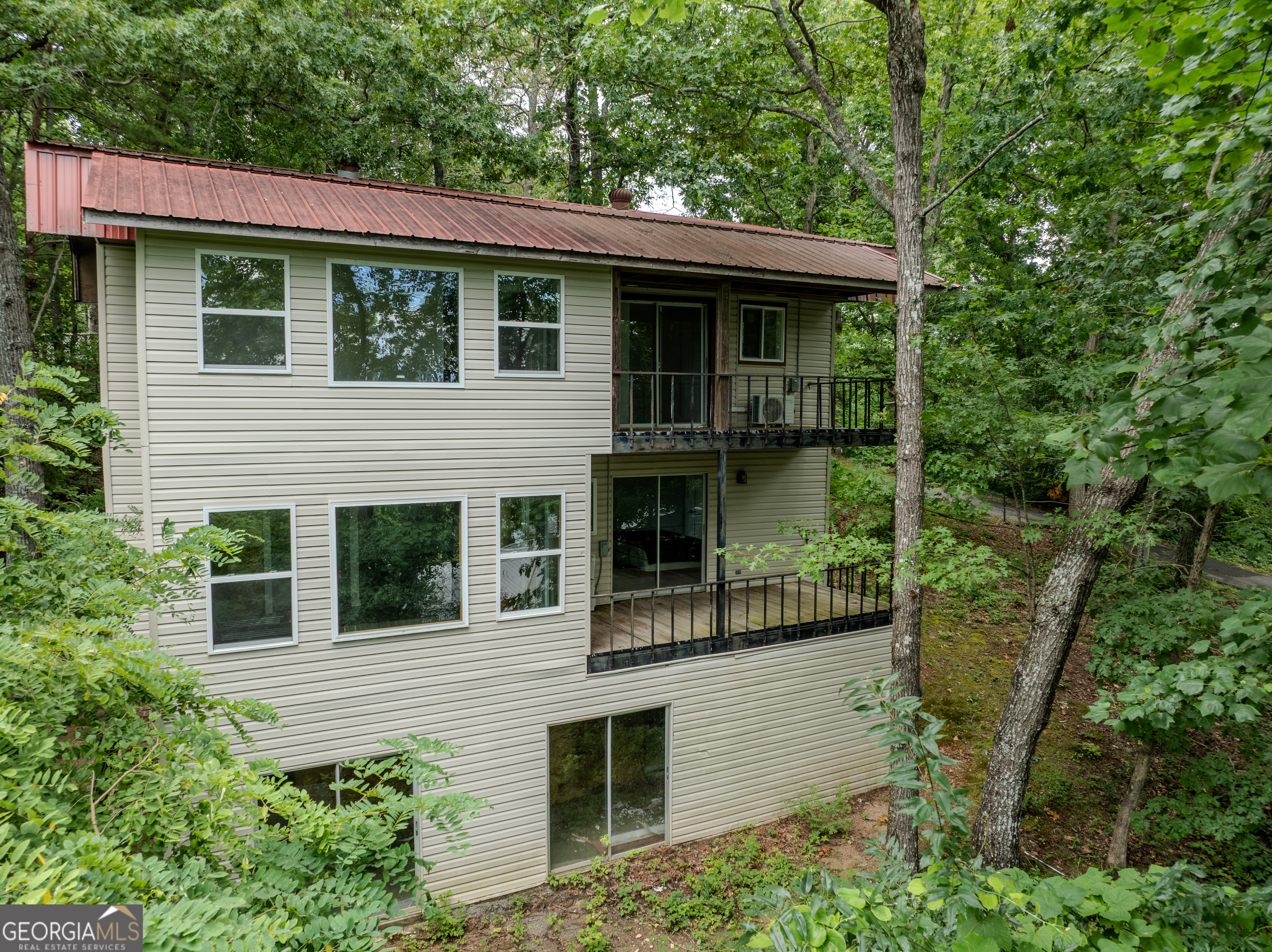 Excellent Investment Opportunity in Charming Chatuge Village - Duplex with Stunning Lake & Mountain Views, and an extra area potentially for storage! Discover the perfect blend of income potential and serene mountain living with this well-maintained duplex/multi-family property in sought-after Chatuge Village, Hayesville, NC. Whether you're looking to grow your rental portfolio or seeking a home that could possibly add additional income potential, this property delivers versatility, location, and breathtaking views. each level features 2 bedrooms and 1 bathroom,kitchen and living room thoughtfully laid out to maximize comfort and functionality. Enjoy peaceful mornings or sunset evenings from the deck, perfectly positioned to capture seasonal views of Lake Chatuge and the surrounding mountains. The home's metal roof offers durability and peace of mind! Chatuge Village is known for its friendly community atmosphere and unbeatable location-just minutes to downtown Hayesville's charming shops, restaurants, and local conveniences. Residents will also enjoy close proximity to public lake access, hiking trails, and all the natural beauty this area is celebrated for. Whether you're an investor, a multi-generational buyer, or someone seeking a home with income potential, this property offers the rare combination of location, views, and opportunity. Deck with picturesque lake & mountain views Excellent rental potential Prime Hayesville location near shops, dining, Lake Chatuge, and recreation Properties like this, with such strong potential and a desirable setting, don't come along often. Schedule your showing today and envision the possibilities!