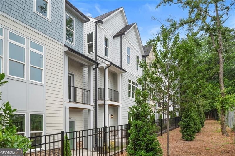 Discover the Baxter plan at Nolyn Pointe by Toll Brothers, situated in the vibrant Chosewood Park area of Atlanta. This elegant 2,742 sq ft home is designed with four bedrooms and 3.5 bathrooms, blending modern sophistication with functional living spaces. As you step inside, the welcoming foyer introduces a convenient guest suite on the main level, followed by stairs leading up to a grand great room. This room, a centerpiece of the home, offers expansive views and access to a covered deck perfect for both lively gatherings and quiet evenings. The heart of the home is the chef's kitchen, featuring a large center island, breakfast bar, substantial counter space, and a walk-in pantry. The kitchen in this home is located in the middle of the main, giving you the clear distinction of the living room on one side and the dining ono the other. The luxurious primary suite on the second floor includes a spacious walk-in closet and an ensuite bath equipped with a dual-sink vanity, large soaking tub, and a seated shower. The third floor houses additional bedrooms, each with ample closet space and a shared bathroom. Thoughtful touches like a powder room on the second floor, laundry on the third, and extra storage spaces throughout the home enhance the everyday living experience. Nolyn Pointe offers a lifestyle of convenience and low maintenance, with included yard care and proximity to Atlanta's BeltLine Southside Trail. This community promises a blend of urban appeal and suburban comfort, making it an ideal setting to enjoy Atlanta's cultural offerings while residing in a peaceful, well-appointed environment. Embrace the perfect mix of luxury and practicality at Nolyn Pointe.