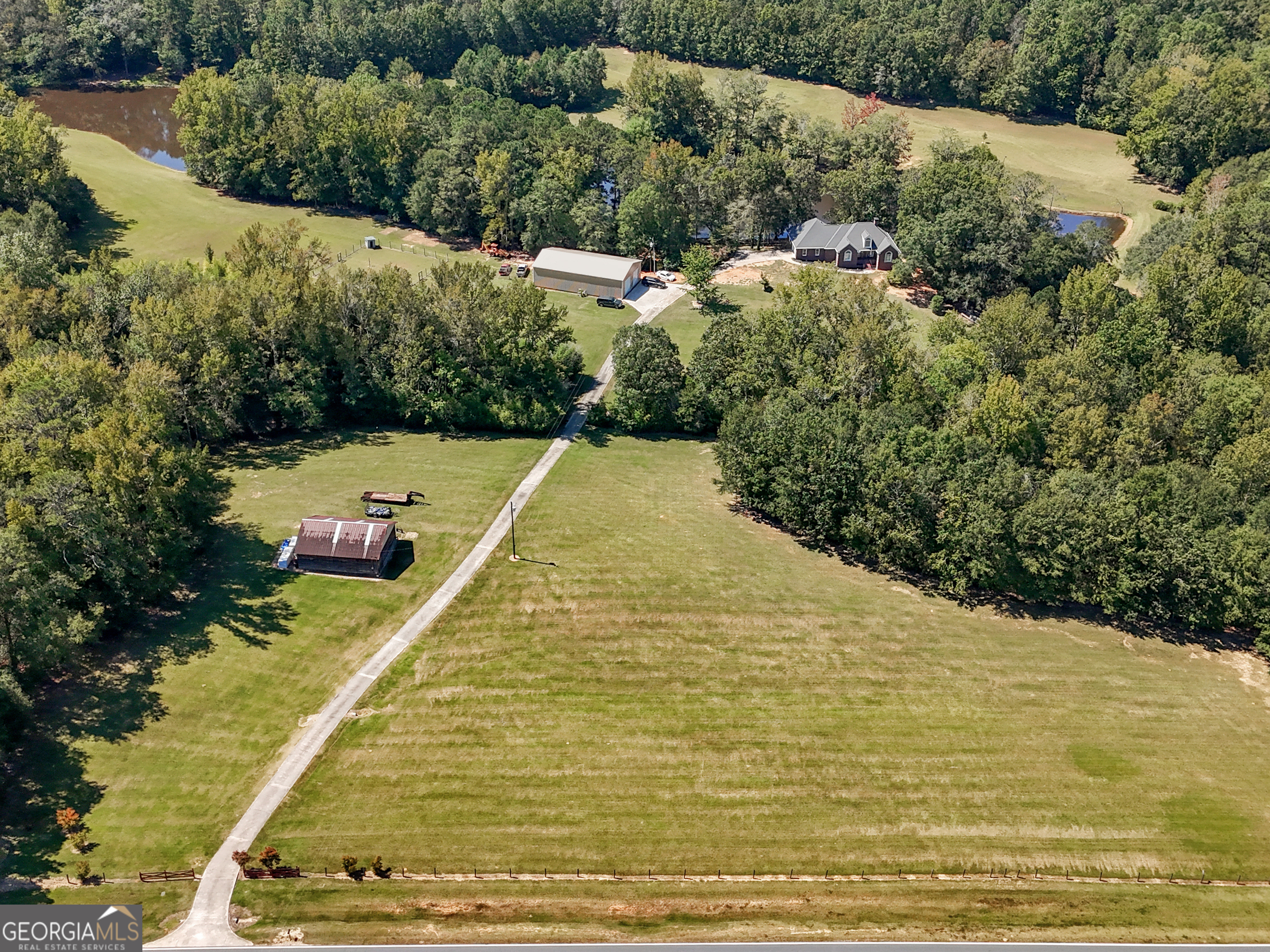 52+ ACRE SERENE ESTATE WITH TWO PONDS IN LAMAR COUNTY OFFERING THE PERFECT BLEND OF A PEACEFUL COUNTRYSIDE. AT THE HEART OF THE PROPERTY IS THE CHARMING MAIN HOUSE THAT HAS BEEN COMPLETELY RENOVATED AND FULL FINISHED BASEMENT OVERLOOKING A 4 ACRE POND AND 2.5 ACRE POND STOCKED WITH BASS, BRIM AND CATFISH. OPEN AND WOODED LAND, A MAN'S DREAM IS THIS NEW 40x70 WORKSHOP WITH 2 ROLL UP DOORS AND ELECTRICITY. PLUS, 32X30 ORIGINAL BARN ON CONCRETE SLAB WITH LOFT. THIS 4 SIDED BRICK HOME FEATURES APPROX 2500 SQ FT THAT HAS BEEN COMPLETELY RENOVATED WITH 3 BR'S, 2 BATHS ON MAIN FLOOR WITH VERY OPEN FLOOR PLAN, NEW FLOORS, NEW LIGHT FIXTURES, NEW UPDATED KITCHEN WITH ALL NEW STAINLESS APPLIANCES, NEW COUNTERTOPS, SEPARATE DINING AREA, LARGE MASTER SUITE WITH SITTING AREA AND LUXURIOUS NEW UPDATED BATHROOM WITH DBL VANITIES, NEW WALK IN TILE SHOWER WITH WATERFALL SHOWER AND WALK IN CLOSETS. LARGE MUDROOM/LAUNDRY , DBL CAR GARAGE. PLANTATION SHUTTERS.YOU WILL LOVE THE FULLY FINISHED BASEMENT JUST RENOVATED INTO A FINISHED BASEMENT WITH LARGE FAMILY ROOM WITH FIREPLACE, 2 BEDROOM'S WITH ONE BEAUTIFUL NEW FULL BATH, WALK-IN CLOSET, STORM SHELTER BULIT -IN AND WORKSHOP WITH ROLL-UP DOOR. YOU CAN DRIVE ALL OVER THE LAND. GREAT FOR HORSES, COWS AND FARMING. BEAUTIFUL AREA OF HOMES WITH ACREAGE. COUNTY WATER, SEPARATE WELL AND SEPTIC TANK. IRRIGATION OUT OF THE POND. A BEAUTIFUL PROPERTY. CLOSE TO HWY 41S. A MUST TO SEE!
