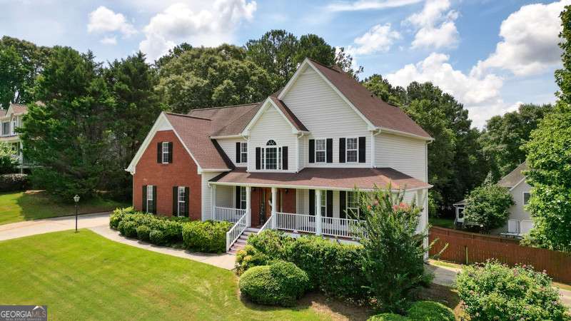 CAR LOVERS, HOBBYIST and RV OWNERS-this is the home you've been waiting for! With two separate 2-car garages, an extra driveway, and a drive-under garage perfect for your big boy toys, classic cars, or RV, this property offers unmatched flexibility and storage for all your vehicles and gear. Whether you're a collector, a craftsman, or just need extra space, this setup is a rare find. Set on a desirable corner lot in a well-maintained neighborhood, this home combines thoughtful design with standout features throughout. Step into a soaring two-story foyer with double coat closets, and enjoy the warmth of updated hardwood floors on the main level, complemented by fresh light fixtures and a spacious layout. The kitchen is a chef's delight, featuring granite countertops, stainless steel appliances, a stylish backsplash, and an extra-long pantry. Enjoy meals or quiet evenings on the screened-in back porch with an adjoining deck, all overlooking your private, fenced backyard oasis complete with a sparkling inground saltwater pool. Upstairs offers plush carpeting and generously sized rooms, while the main-level laundry room adds everyday convenience. Major updates are already taken care of, including a 5-year-old roof, HVAC, and water heater. The unfinished basement offers endless potential-transform it into the ultimate game room, recreation space, or expanded workshop. This home has it all: space, style, and versatility in a location you'll love.