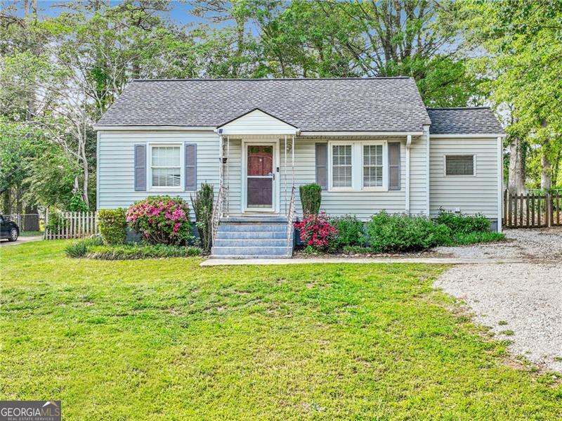 Welcome Home! Don't miss this charming 2 bed 1 bath located in Fairburn! This cozy home boasts beautiful hardwood floors, built-in charming shelving in the living room, light filled big windows, and lots of storage! Separate laundry room for added storage and convenience with tons of cabinets, countertops, and space to have a little office! Outside features a huge fenced-in backyard, perfect for entertaining, gardening, or relaxing in privacy! Located just minutes from everyday essentials and recreation - only 9 minutes to Ronald Bridges Park, 8 minutes to Kroger and Walmart Supercenter, and just a quick 15 minute drive to Hartsfield-Jackson Atlanta International Airport. Whether you're a first-time homebuyer, downsizing, or looking for an investment opportunity, this home offers charm, convenience, and value!