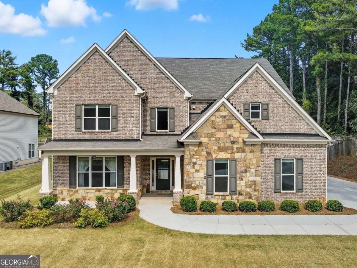 Welcome to 810 Eagle Crossing, a show-stopping 5BR/4BA home on a full acre in the Brookwood school district! Built in 2017 and packed with upgrades, this home blends elegance, function, and outdoor living. Step inside to find rich trim details, upgraded lighting, and a unique custom coffered ceiling. The heart of the home is the chef's kitchen with an enormous island featuring cabinets on both sides, double ovens, gas range with hood, and an amazing custom pantry. The kitchen opens to the family room with a stacked stone, wood-burning fireplace and built-ins. Main level also offers a large dining room, home office, guest suite with full bath, and mudroom. Upstairs, retreat to the oversized primary suite with spa-style bath including an extra-large tiled shower with dual heads, whirlpool tub, and expansive walk-in closet. Generous closets in all bedrooms provide storage galore. Outdoors is an entertainer's dream: an extended patio with awnings, custom stonework with fire pit, extra-large garden shed, pergola, gazebo, and fully fenced yard with fruit trees (peach & plum), blueberry bushes, and a mature grapevine with multiple varieties. Home also includes a whole-house WiFi access point for modern convenience. All of this with no HOA, minutes to parks, dining, shopping, and restaurants on Scenic Hwy. A rare combination of luxury, storage, and lifestyle in one of Lawrenceville's most desirable locations!