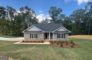 Under Construction! The 2604 floorplan, a stunning 1.5-story, brick and stone front home on a full finished basement nestled on an expansive 2.92-acre estate sized lot located at homesite 90 in Tuscany Hills, Douglasville, GA. This 5-bedroom, 4-bathroom residence offers at total of 3900 square feet of modern elegance with a thoughtfully designed layout. The open floor plan is highlighted by luxury vinyl plank flooring throughout the main living spaces and wet areas, while the bedrooms are cozy with plush carpeting. The gourmet kitchen boasts stainless steel appliances, a beautiful tile backsplash, and ample counter space, perfect for culinary enthusiasts. Enjoy gatherings by the charming wood-burning fireplace in the spacious living area or step outside to the deck, ideal for outdoor entertaining. This full finished basement offers a spacious and inviting retreat, featuring plush wall-to-wall carpeting that adds warmth and comfort throughout. The open-concept recreation room provides ample space for entertainment, whether it's a home theater, game room, or fitness area. Natural light pours in through large windows, creating a bright and airy atmosphere. A beautifully designed full bath includes a modern vanity, sleek tile flooring, and a luxurious shower, offering both convenience and style. The seamless flow from the recreation space leads to a walk-out deck, perfect for outdoor relaxation and entertaining. A side-entry 2-car garage adds to the curb appeal and functionality. You have plenty of room driveway is about 250ft plenty of room for guest. Located just minutes from I-20 West and the vibrant Chapel Hill area, Tuscany Hills offers a peaceful suburban lifestyle with easy access to shopping, dining, and entertainment. Residents of Tuscany Hills enjoy large estate-size lots, serene surroundings, and the convenience of nearby Douglasville amenities, all while being within commuting distance of downtown Atlanta. Make this stunning home yours and experience the luxury and charm of Tuscany Hills living!