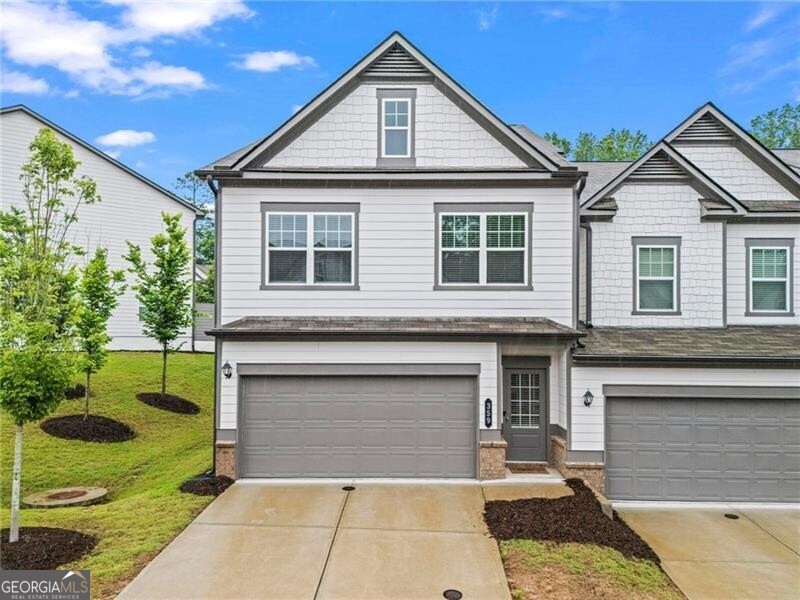 Welcome to this well-maintained end-unit townhome in the desirable Concord community! Built in 2022, this 3-bedroom, 2.5-bath home offers a comfortable and functional layout. The open-concept main level features a modern kitchen with granite countertops, stainless steel appliances, and plenty of cabinet space. The living room includes a cozy fireplace and opens to a private back and side yard-great for both relaxing and entertaining. Upstairs, the spacious primary suite includes a walk-in closet, dual vanities, and a tiled shower. Two additional bedrooms and a full bath provide flexibility for guests, a home office, or additional living space. Additional features include a two-car garage, low-maintenance yard, and a quiet, walkable community with sidewalks and dog stations. Conveniently located between Woodstock and Roswell, with easy access to schools, shopping, and more. This move-in ready home offers great value in a great location!