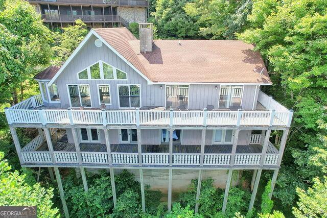 New Price Reduction for this large 4-bedroom, 3-baths move in ready home. It comes complete with all the furnishings, including bedding, towels, lamps, sofas, beds, 5 TVs, dishes, silverware, pans, etc. Seriously, just bring clothes, and a toothbrush. It will be easy to get on the Sky Valley rental market quickly. Come see it today. The original-owner home in Sky Valley, Georgia's highest and coolest city, features phenomenal mountain views. The main floor includes an updated kitchen with stainless steel appliances, breakfast nook with wrap-around windows, separate utility room, primary bedroom and adjoining updated bath with two vanities, and a second bedroom and hall bath. The open-plan kitchen/family room/dining area features a vaulted ceiling, a massive stone wood-burning fireplace and updated LVT flooring. Also, a nice sized laundry room on main floor. Views from every room. The lower floor contains two bedrooms, an updated bath and a large wood-paneled family/game room with a stone wood-burning fireplace. Each floor is served with a full-length deck. All the bedrooms in this home are spacious, with each having a sliding glass door to the enjoy the view and there is lots of storage. With the exception of a few personal and family items, most furnishings will convey. Ready for your family and it has been a successful vacation rental. Sky Valley is located two hours from Atlanta and 15 miles from Highlands, NC, features easily accessible city-maintained paved streets, a semi-private 18-hole, 6900-yard championship golf course at Sky Valley Country Club (membership optional), public water system, police department, garbage collection, volunteer fire department, two churches, pickleball courts and post office. Short-term rentals are allowed in Sky Valley. There is no HOA.