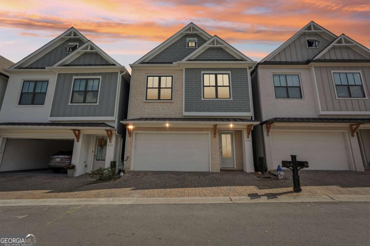 Welcome home to The Village at Towne Lake, a premier gated community in the heart of Woodstock! This beautifully maintained two-story residence, built in 2022, offers 3 bedrooms, 2.5 baths and over 2,000 square feet of modern living space designed with comfort and style in mind. Inside, you'll love the bright open layout featuring a gourmet kitchen with white cabinetry, stone counters, stainless appliances, a spacious island, and a view to the family room. The inviting living area is anchored by a cozy electric fireplace, while the oversized primary suite boasts a double vanity and walk-in closet for easy luxury. Upstairs laundry with a sink makes everyday living effortless.Step outside to enjoy a rear porch and landscaped lot, perfect for relaxing or entertaining. The community itself is loaded with amenities-clubhouse, pool, tennis, pickleball, and walking trails-all just minutes from vibrant Downtown Woodstock's shopping, dining, and entertainment.Additional features include a two-car garage, high ceilings, crown molding, and energy-efficient design. HOA covers lawn maintenance, giving you more time to enjoy everything this sought-after neighborhood has to offer. This home blends the best of low-maintenance living with modern elegance-don't miss your chance to make it yours!