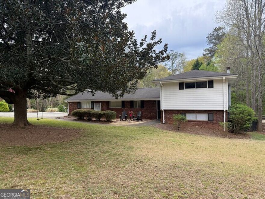 Exceptional Opportunity in a Prime Alpharetta Location! Nestled in a prestigious neighborhood just a short walk from vibrant Downtown Alpharetta, this charming 3-bedroom, 2-bathroom split-level home is situated on a desirable corner lot. Offering lots of living space, this property presents a rare opportunity for renovation, expansion, or a complete custom rebuild to create the home of your dreams. Positioned in a sought-after community known for its excellent schools, upscale dining, and boutique shopping, this residence provides an ideal blend of convenience and potential. Whether you envision modernizing the existing structure or designing a brand-new masterpiece, this lot's prime location ensures lasting value. Property is being sold as-is. Don't miss out on this exceptional investment in one of Alpharetta's most coveted areas!