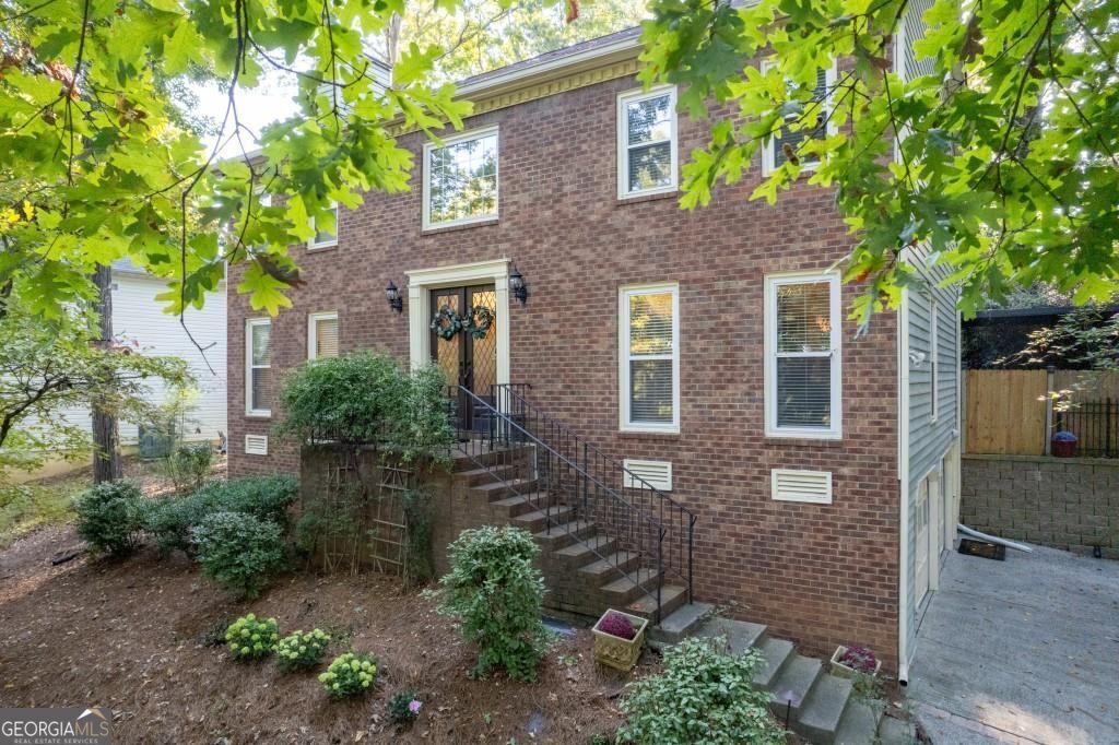 Welcome to this classic brick home in the highly desirable Lansdowne neighborhood-known for its swim and tennis amenities and friendly community vibe. This home has the perfect mix of charm and thoughtful updates that make everyday living easy and entertaining even better. Inside, you'll find a bright, welcoming layout with French doors, great natural light, and a cozy fireplace in the family room. The kitchen has everything you need-white cabinets, stone counters, a gas range, and even a tucked-away desk area for work or homework. It opens right into a sunny breakfast room and a great sunroom that leads out to the deck. Out back, you'll find a private, wooded yard with a large deck, patio, and a swim spa lap pool/hot tub that makes relaxing or entertaining a breeze. Upstairs, the oversized owner's suite has a tray ceiling, a beautifully updated bathroom with a skylight, soaking tub, double vanity, and a big custom walk-in closet. Three more bedrooms share a hall bath, and there's a separate laundry room up there too. The finished basement adds even more space with its own kitchen, bedroom, full bath, laundry, and separate entrance-perfect for guests, in-laws, or even rental potential. You're just minutes from shopping, restaurants, parks, and highways, and it's zoned for some of East Cobb's top-rated schools. Come see it in person-you'll feel right at home.