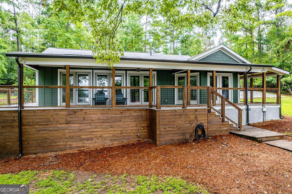 Completely Remodeled Lake Sinclair Cottage Discover this beautifully updated 4-bedroom, 3-bath home tucked away in a private lakeside setting. Inside, you'll find generously sized bedrooms and a stunning kitchen featuring solid surface countertops, abundant storage, and premium KitchenAid appliances. The inviting covered porch is perfect for relaxing while enjoying the gorgeous lake view. With its spacious layout, peaceful location, and modern finishes throughout, this home is ideal for both everyday living and weekend getaways.