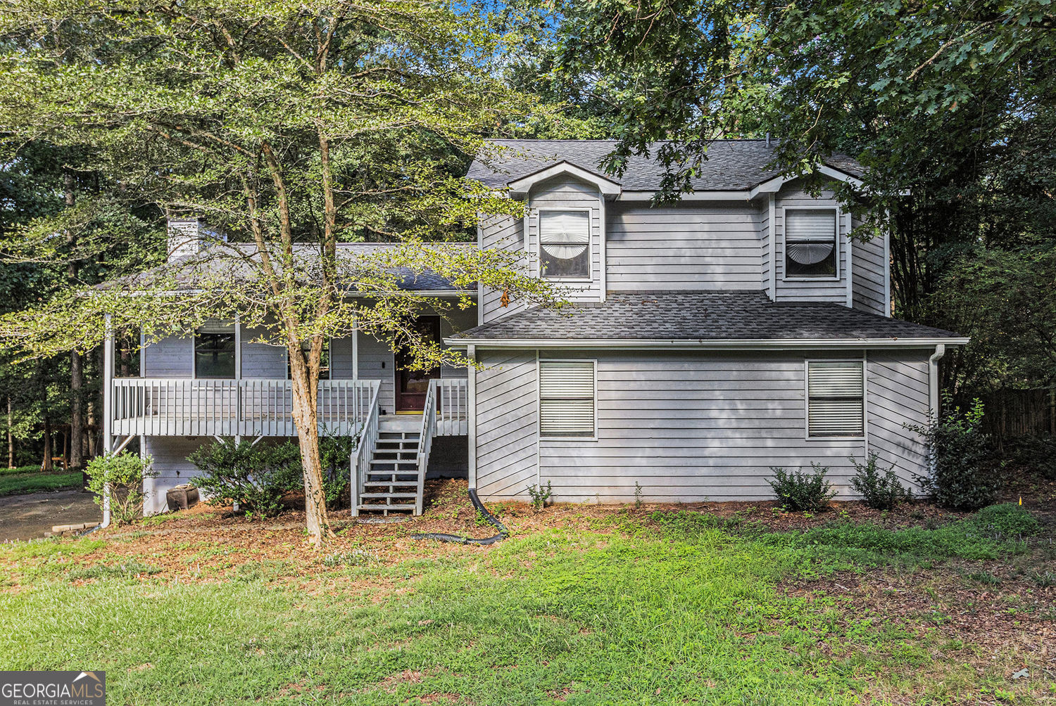 Welcome to your beautiful and spacious split-level home. This home offers an oversized living room that has gorgeous new LVP flooring and a stone fireplace to the ceiling, perfect for entertaining. As you go to the upper level you will find three large bedrooms all with new carpet. Both bathrooms have tile flooring along with a jacuzzi tub in the master bath. Down a few steps off the main level, you will enter the spacious kitchen and breakfast area with hardwood flooring and granite countertops, stainless steel appliances including a new refrigerator and beautiful cabinets. Also included on this level is a half bath and separate laundry room as well as a huge bonus room which can be used for a myriad of purposes. Running along the back of the house is a private two-tiered deck that is accessed from the living room and kitchen. You will feel the serenity as you step out on to your deck looking out over a wooded area that is part of the Dupree Park. No HOA and a large level lot makes it even better. With your location just 2 miles from downtown Woodstock and all that it has to offer including the Amphitheater and great restaurants, shops and nightlife you will love your new home. Minutes to 575 and Hwy 92/Arnold Mill, also close to Roswell, Milton, Cobb and Canton.