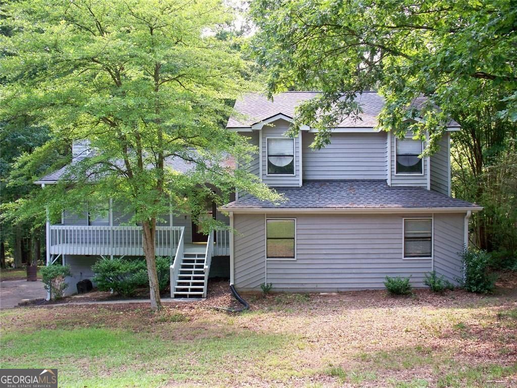 Welcome to your beautiful and spacious split-level home. This home offers an oversized living room that has gorgeous new LVP flooring and a stone fireplace to the ceiling, perfect for entertaining. As you go to the upper level you will find three large bedrooms all with new carpet. Both bathrooms have tile flooring along with a jacuzzi tub in the master bath. Down a few steps off the main level, you will enter the spacious kitchen and breakfast area with hardwood flooring and granite countertops, stainless steel appliances including a new refrigerator and beautiful cabinets. Also included on this level is a half bath and separate laundry room as well as a huge bonus room which can be used for a myriad of purposes. Running along the back of the house is a private two-tiered deck that is accessed from the living room and kitchen. You will feel the serenity as you step out on to your deck looking out over a wooded area that is part of the Dupree Park. No HOA and a large level lot makes it even better. With your location just 2 miles from downtown Woodstock and all that it has to offer including the Amphitheater and great restaurants, shops and nightlife you will love your new home. Minutes to 575 and Hwy 92/Arnold Mill, also close to Roswell, Milton, Cobb and Canton.