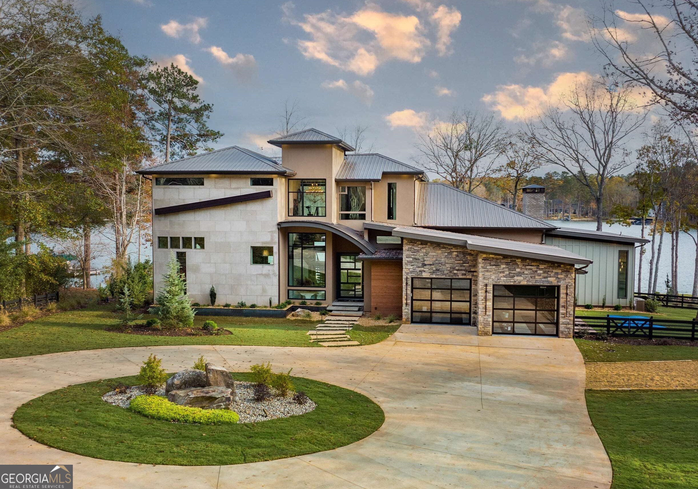 STUNNING WATERFRONT HOME ON HIGHLY SOUGHT AFTER RICHLAND SIDE OF LAKE OCONEE. Every detail of this Intricately Designed Home has been Hand Selected and Impeccably Designed. The Perfectly Landscaped Lot overlooks the Prestigious Homestead of Reynolds at Lake Oconee. The Soft Modern, Yet Comfortable Design, welcomes you the moment you pass through the Custom Designed Pivoting Front Door. Entering an Oversized Foyer, you are immediately captivated by Stunning Lake Views from every angle. Soaring Ceilings, A Floating Staircase & Exposed Brick Walls are Immediate Breath Takers. The Sprawling Open Floor Plan is An Entertainers Dream. An Elaborate Chef's Kitchen features An Oversized Island, 6 Burner Gas Range + Grill, Double Ovens, Sub-Zero Refrigerator, Wine Tower, Dual Drink Drawers, Full Wine Bar, Magnificent Chandelier, & Walk-In Pantry with Direct Plumbed Coffee Station. The Main Floor boasts Two Bedrooms with Private Exterior Access, Two Full Baths & Walk-In Closets. You will also enjoy an Oversized Dining Room, Private Office, Sexy Powder Room, & Large Utility Room. An Extra Special Bonus for Your Fur Babies includes a Huge Walk-in Shower, Elevated Meal Station, and Direct Access to a Large, Fenced-In Dog Park complete with Artificial Turf, their very own Splash Pad, Tether Ball, Fire Hydrant, and Stunning Lake Views of course! The Gorgeous Cable Railed Staircase leads you to an Upper Level Glass Enclosed Gym with 180 Degree Water Views. In addition to the Cozy Reading Nook, there are Two Oversized Bedrooms, with Ensuite Baths, Walk-In Closets, and Direct Exterior Access with Breathtaking Views. The Home features a Lutron Smart House Lighting System, Sonos Speaker System with iPad Control throughout, Whole House Water Softener, Reverse Osmosis System, Sprayfoam Insulation, and Tankless Water Heater. Attention to Detail on the Exterior is equally captivating with Designer Lighting, A Multitude of Finishes, Metal Roof, Professional Landscaping, Glass Garage Doors, Circular Drive, Infinity Edge Pool w/ Spa & Fire Bowls, Floating Walkways, Max Dock, Hydraulic Boatlift, and Jet Ski Lifts. Simply put... it is Stunning. The pictures are Astonishing and the home is even better in person. Show stopper!