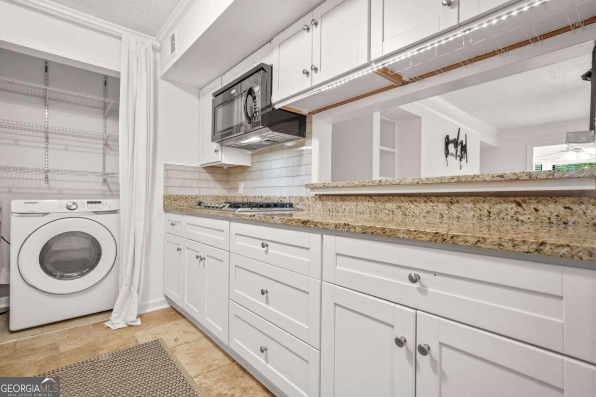 Fantastic, updated condo in Marietta / East Cobb! This one bedroom, one bath unit has so much to offer for under $200,000. The wide open concept begins with the kitchen, with it's white cabinetry, granite countertops, stainless appliances and a passthrough / breakfast bar. The kitchen opens to the dining space, perfect for intimate meals or larger, family gatherings. The open floorplan continues into the large, fireside family room, complete with built in shelving. Off the family room is a light filled sunroom, ideal for enjoying morning coffee or as an office or reading room. Step outside the sunroom onto your private deck, to grill out or enjoy an evening glass of wine. At the end of a long day, retire to the spacious bedroom suite. The bedroom also offers access to the roomy deck, and includes an updated bath with a fully tiled shower. All of this in such a great community. Enjoy low, Cobb County taxes, easy access to highways and less than two miles to Truist Park / The Battery. Just across the street is wonderful Market Place Terrell Mill, with it's abundance of shopping, dining, entertainment and a band new Kroger! The community itself offers a pool and playground. Don't miss the opportunity to make this great condo your own!
