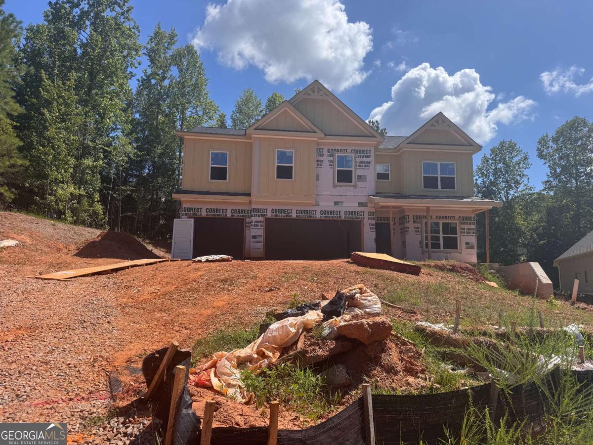 Just Listed New Construction in Traditions of Braselton! Built by Park Stone Legends LLC - this is the home YOU have been waiting for! Welcome to your dream home in the heart of the Traditions of Braselton-a premier golf, swim, and tennis community! This brand new home features 5 spacious bedrooms and 4 full baths, offering luxury and comfort for every lifestyle. Situated on a quiet cul-de-sac, this home boasts an open-concept layout, chef's kitchen with designer finishes, and a main-level guest suite; which could also be used as a home office! The chef's kitchen will include gas cooktop / wood vent / double ovens and micro above! (do not have pics of a finished kitchen). ALSO - access to the dining area featuring coffered ceilings and wood detail trim! The Primary Suite upstairs is HUGE and has a sitting area! The spa-inspired bath will have a frameless shower and stand alone tub! Off the bathroom is the daylight walk-in primary closet! Secondary spacious bedrooms on the upper level as well as a Loft / Flex Space - perfect for a playroom! There is also an en-suite upstairs with it's own private bath! The outdoor covered patio with a cozy fireplace is perfect for year-round entertaining. THERE IS CURRENLTY STILL TIME TO CUSTOMIZE IF YOU ACT QUICKLY!! All of Park Stone Legends homes come with a gas tank from Blossman Gas that runs to the cooktop & fireplaces! Enjoy the lifestyle you've always wanted with resort-style amenities, scenic golf course views, and the charm of a close-knit neighborhood. Estimated completion end of September 2025. **some images are stock images / staged of previous Belmont Plan**