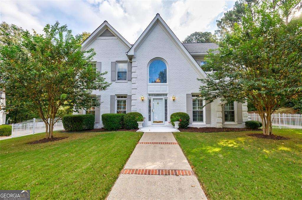 Timeless all-brick home on a quiet cul-de-sac with a level lot and fenced, walkout backyard-perfect for cookouts, kids, or pets. Step inside to a bright, open layout with oversized rooms and a crisp white interior that feels both fresh and inviting. Enter through the two-story foyer with wood floors, new double-pane windows, and gorgeous architectural details. The dining room, large enough to seat 12+, flows into the upgraded chef's kitchen featuring Jenn-Air stainless steel appliances (including a wine cooler), abundant cabinetry with a built-in pantry, a walk-in pantry with shelving, and a vaulted dining area where everyone naturally gathers. The spacious great room is ideal for movie nights, entertaining, or working from home, while the separate family room with custom built-ins opens directly to the backyard, seamlessly blending indoor and outdoor living. Upstairs, the primary suite is your private retreat with a trey ceiling, dual walk-in closets, and a vaulted spa-like bath. Generous secondary bedrooms provide flexibility for family, guests, or a home office. All of this in a prime Sandy Springs location close to shopping, dining, Dunwoody Country Club and Dunwoody Village plus quick access to Peachtree Corners and top private and public schools!