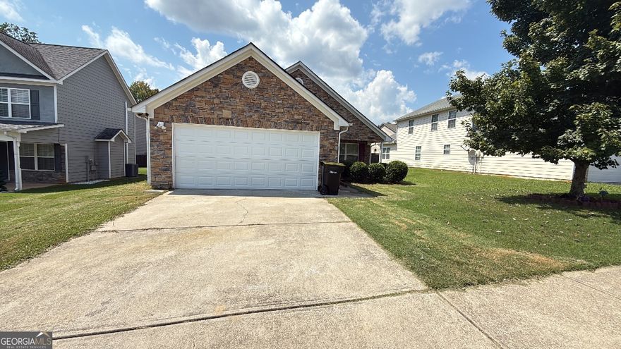 5.25% Assumable FHA with Roam! Step into this beautifully refreshed, single-family ranch nestled in the heart of Lovejoy Station. Ideal for modern living, the home welcomes you through a bright entry into an open living space anchored by a charming fireplace and newly installed tile and laminate floors that flow throughout. The kitchen and adjoining areas are outfitted with sleek, updated appliances and boast fresh paint inside and out, offering a crisp, inviting backdrop. Three comfortable bedrooms and two full baths deliver a well-thought-out layout, while the expansive two-car garage adds convenience and versatility. Outside, a brick-and-stone facade and newly landscaped setting complete the curb appeal, making this a compelling and move-in-ready gem in a neighborhood convenient to schools, shopping, and major thoroughfares.