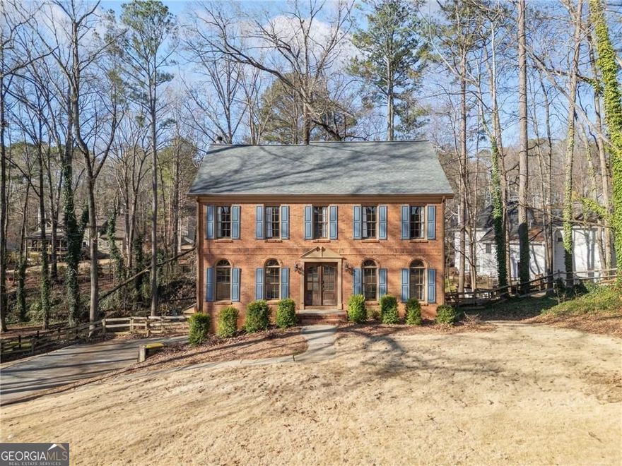 Welcome to this beautifully maintained Colonial-style home in the heart of Towne Lake, just minutes from the vibrant charm of Downtown Woodstock. Classic curb appeal sets the tone with timeless architecture and a welcoming front entry. Step inside to discover a thoughtfully designed interior where tradition meets modern comfort.    Wide-plank hardwood floors stretch across the main level, creating warmth and flow throughout. Farmhouse-inspired fixtures and tasteful finishes add character at every turn. The updated kitchen is the heart of the home with granite countertops, painted cabinetry, stainless steel appliances, and wainscoting accents. Whether you're sipping your morning coffee or hosting friends, this space is made to gather and enjoy.    Upstairs, the primary suite is a peaceful retreat with a tray ceiling and a beautifully renovated bath featuring dual vanities, custom wood-trimmed mirrors, stylish tile details, a separate shower, and a spacious walk-in closet. Three secondary bedrooms share an updated hall bath, offering comfort and convenience for everyone. The finished basement adds even more flexibility with an extra bedroom or bonus space to fit your lifestyle.    Step outside to enjoy the fresh air on a double-tier deck overlooking a large, private backyard. Whether you're entertaining, gardening, or simply relaxing, this outdoor space is ready for every season.    New updates throughout the home add to its appeal, making it move-in ready and easy to love. Located in the highly sought-after Etowah High School district, this home also offers convenient access to shopping, dining, and entertainment. Thoughtfully maintained and ready for new memories-this one checks all the boxes.