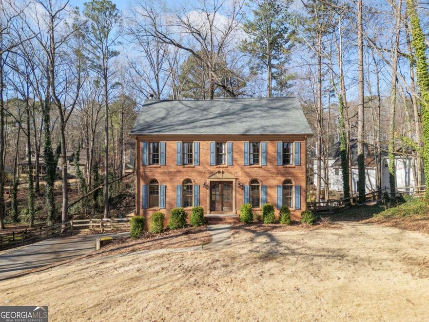 Welcome to this beautifully maintained Colonial-style home in the heart of Towne Lake, just minutes from the vibrant charm of Downtown Woodstock. Classic curb appeal sets the tone with timeless architecture and a welcoming front entry. Step inside to discover a thoughtfully designed interior where tradition meets modern comfort.    Wide-plank hardwood floors stretch across the main level, creating warmth and flow throughout. Farmhouse-inspired fixtures and tasteful finishes add character at every turn. The updated kitchen is the heart of the home with granite countertops, painted cabinetry, stainless steel appliances, and wainscoting accents. Whether you're sipping your morning coffee or hosting friends, this space is made to gather and enjoy.    Upstairs, the primary suite is a peaceful retreat with a tray ceiling and a beautifully renovated bath featuring dual vanities, custom wood-trimmed mirrors, stylish tile details, a separate shower, and a spacious walk-in closet. Three secondary bedrooms share an updated hall bath, offering comfort and convenience for everyone. The finished basement adds even more flexibility with an extra bedroom or bonus space to fit your lifestyle.    Step outside to enjoy the fresh air on a double-tier deck overlooking a large, private backyard. Whether you're entertaining, gardening, or simply relaxing, this outdoor space is ready for every season.    New updates throughout the home add to its appeal, making it move-in ready and easy to love. Located in the highly sought-after Etowah High School district, this home also offers convenient access to shopping, dining, and entertainment. Thoughtfully maintained and ready for new memories-this one checks all the boxes.