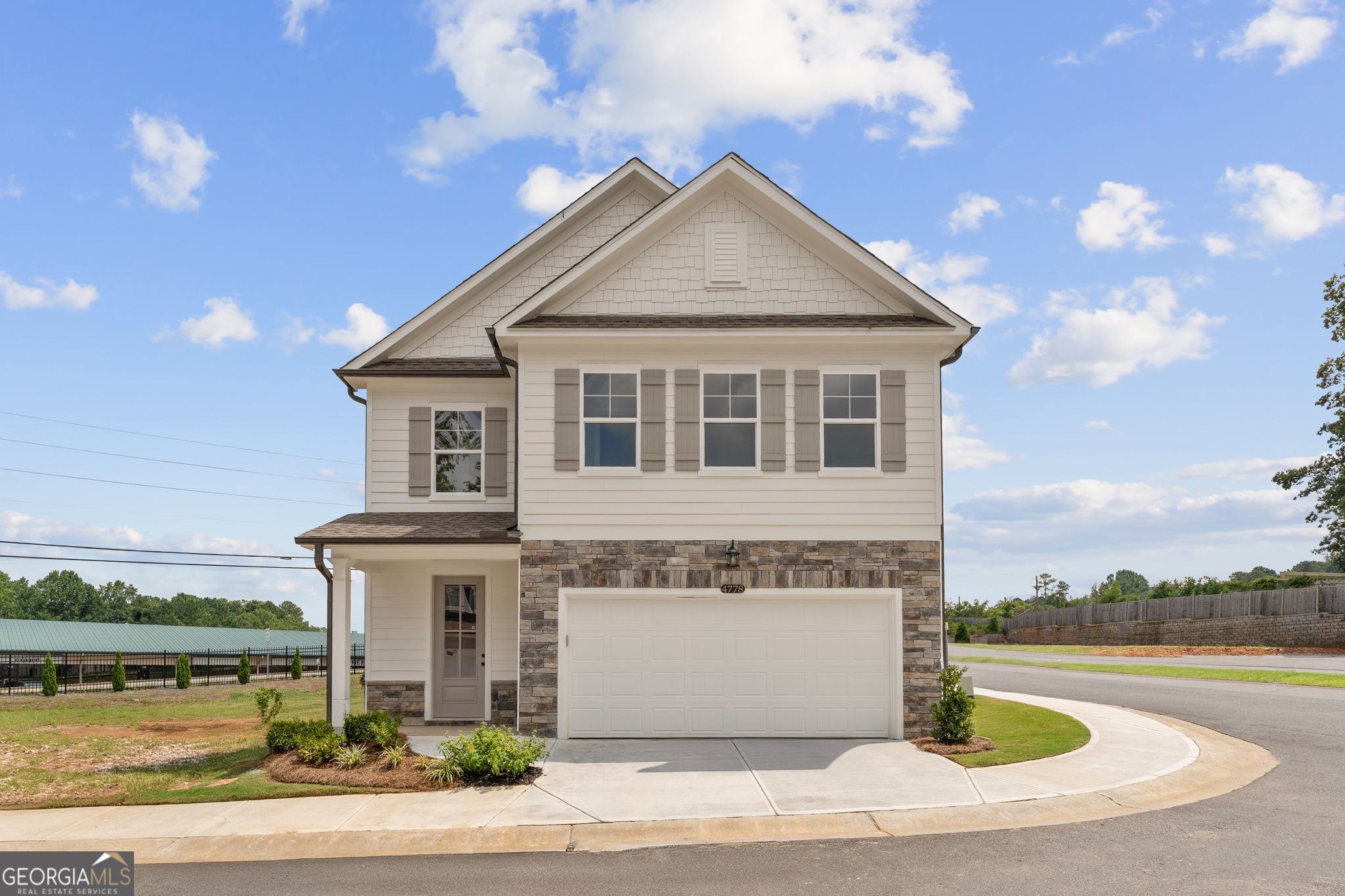 Only Three Gavins Left! Introducing The Gavin F at The Village at Shallowford, a stunning 4-bedroom, 3.5-bathroom home with 2,233 square feet of thoughtfully designed living space. Ready for immediate move-in, this home showcases an open-concept layout with a spacious living room, a gourmet kitchen and custom upgraded features. The kitchen is a true showpiece with 42" cabinets, in custom Maddax sage with modern soft-close drawers, a walk-in pantry, premium quartz countertops, a contemporary stainless steel farmhouse sink, and an oversized island perfect for entertaining. A cozy breakfast area and a convenient mudroom complete the main level. Upstairs, the loft has been upgraded into a fourth bedroom with a full bathroom option, complementing two additional secondary bedrooms. The oversized primary suite impresses with a trey ceiling, expansive walk-in closet, and a spa-inspired frameless shower conveniently located next to the laundry room. Luxury details are found throughout, including no carpet in the entire home, luxury vinyl plank flooring, oak tread stairs, frameless showers, and striking stone exterior accents. Set within the ONLY gated community with a pool and clubhouse in Kennesaw, enjoy quality amenities and proximity to excellent schools. With its charming exteriors and open floor plans, this home is a true gem. Schedule your showing today and experience all that The Gavin F has to offer. *Attached photos may include upgrades and non-standard features and are for illustrative purposes only. They are not an exact representation of the home. Actual home will vary due to designer selections, option upgrades and site plan layouts.