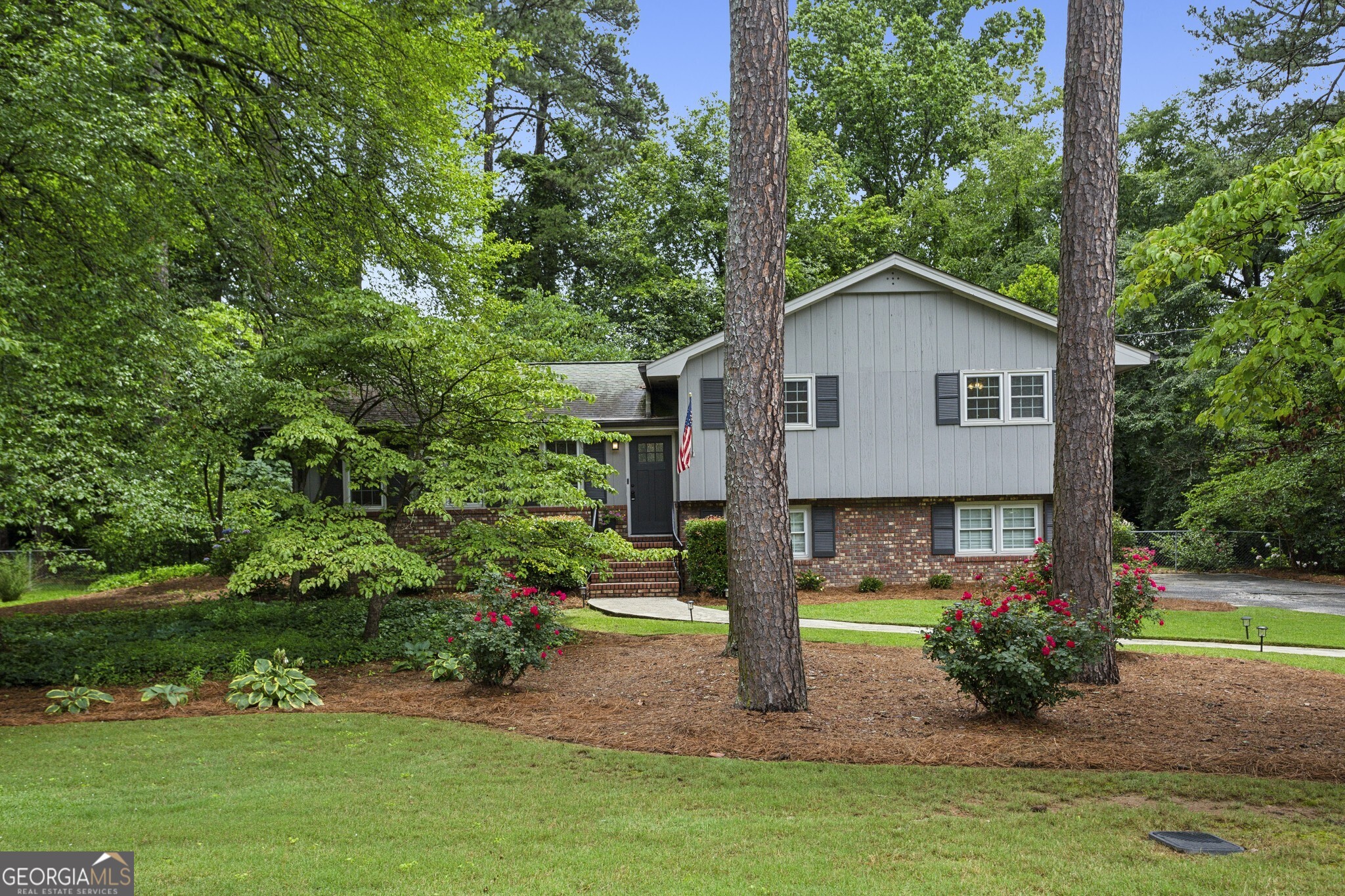 Tucked in the Highly Sought-After Stratford Community, This Move-In Ready Home Blends Modern Updates with Timeless Charm in a Prime Location Near The Battery, Marietta Square, and Smyrna Market Village. Step inside to discover a thoughtfully updated layout featuring a light-filled Family Room, stunning vaulted Den with exposed beams, and a cozy Brick Fireplace framed by expansive windows overlooking the private backyard. The updated Kitchen is a true showpiece, complete with timeless Gray Cabinetry, Granite Countertops, and a stylish Herringbone Backsplash perfectly open to the Breakfast Area and entertaining spaces. The spacious Dining Room easily accommodates gatherings, while the open-concept flow allows for both everyday comfort and special occasions. Retreat upstairs to a serene Primary Suite with a beautifully Renovated Ensuite Bath, featuring marble-style tile and a glass walk-in shower. Two additional bedrooms share an updated Hall Bath, ensuring comfort for everyone. Out back, enjoy a Fully Fenced Yard with lush landscaping, a large Deck for outdoor dining, a charming Patio Area, and even a Garden Shed creating your own private oasis. The mature trees and level lawn make this a standout for relaxing or play. Located minutes from top dining, shopping, and Braves games, this home checks all the boxes for lifestyle, location, and layout.