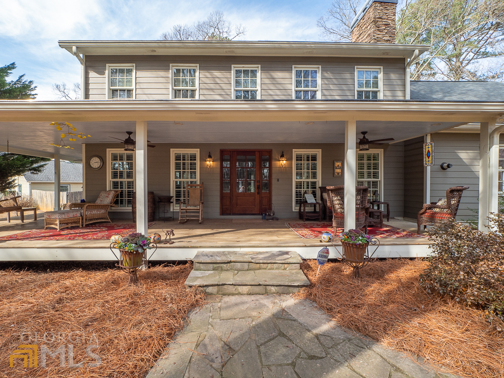 Welcome home to this charming home in the heart of East Cobb! With a thoughtful, extensive renovation and addition (including primary bedroom on main floor), this property has a wonderful open, flowing floorplan and is an entertainer's delight. From the huge covered front porch that wraps around the house on the side, to the large dining room open to the kitchen and spacious chef's kitchen open into the living room, to the back patio with built in fireplace, this home was made for gathering friends & family. Hardwoods are found throughout both levels as well as newer windows, plantation shutters & recessed lighting throughout first floor. Dining room features one of two fireplaces with built in china cabinet on either side, offering character and practical storage that's hard to find in this part of town. Kitchen had a full remodel and includes a built in fridge/freezer, stainless steel double oven with cafe doors on top, a 6-burner gas cooktop with griddle, under counter ice machine, expansive island with granite counters, and custom cabinetry including 2 pantries. Living room was expanded and centered by a gas fireplace and mantel, and also offers a built-in entertainment center and dry bar with double refrigerated drink drawers. On other side of kitchen is command center/build in desk and main floor primary bedroom addition, with walkout to backyard patio, and full bath addition including soaking tub, double vanity, separate shower, water closet, and 2 walk in closets (it even has a pass-through drawer from master closet into laundry room!). Upstairs, find the original master bedroom suite with 2 closets, 2 secondary bedrooms, and spacious bonus room as well as updated bathrooms. Other updates include roof, gutters, hardie plank siding, tankless water heater, 3 HVAC units, electric panel, and professional landscaping with front yard irrigation system. All of this in one of East Cobb's friendliest neighborhoods with swim, tennis, playground, clubhouse, social groups (even pickleball!) and plenty of parties.